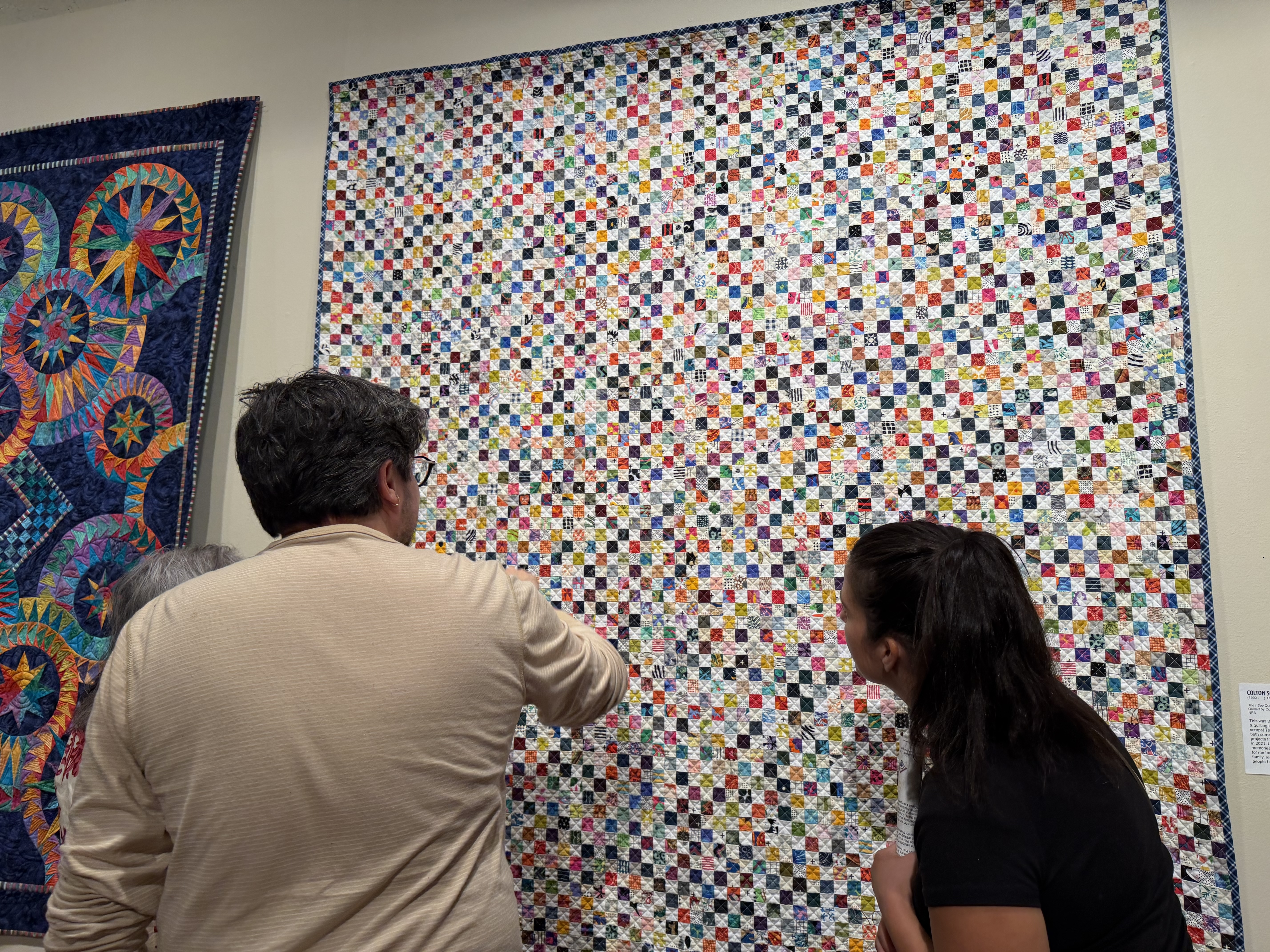 Colton Schille Smith talks about his quilt titled "The I Spy Quilt" to fellow museum patrons at the Springville Museum of Art on Friday.
