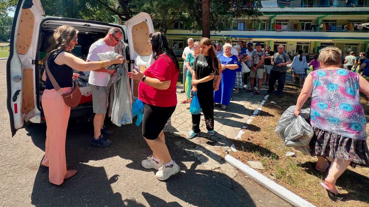 Mindie Packer of Riverton, left, recently returned from her 10th humanitarian trip to Ukraine and is pressing for continued aid for the country in its war with Russia. She's pictured handing out aid in Sheptytskyi, a Ukrainian city.