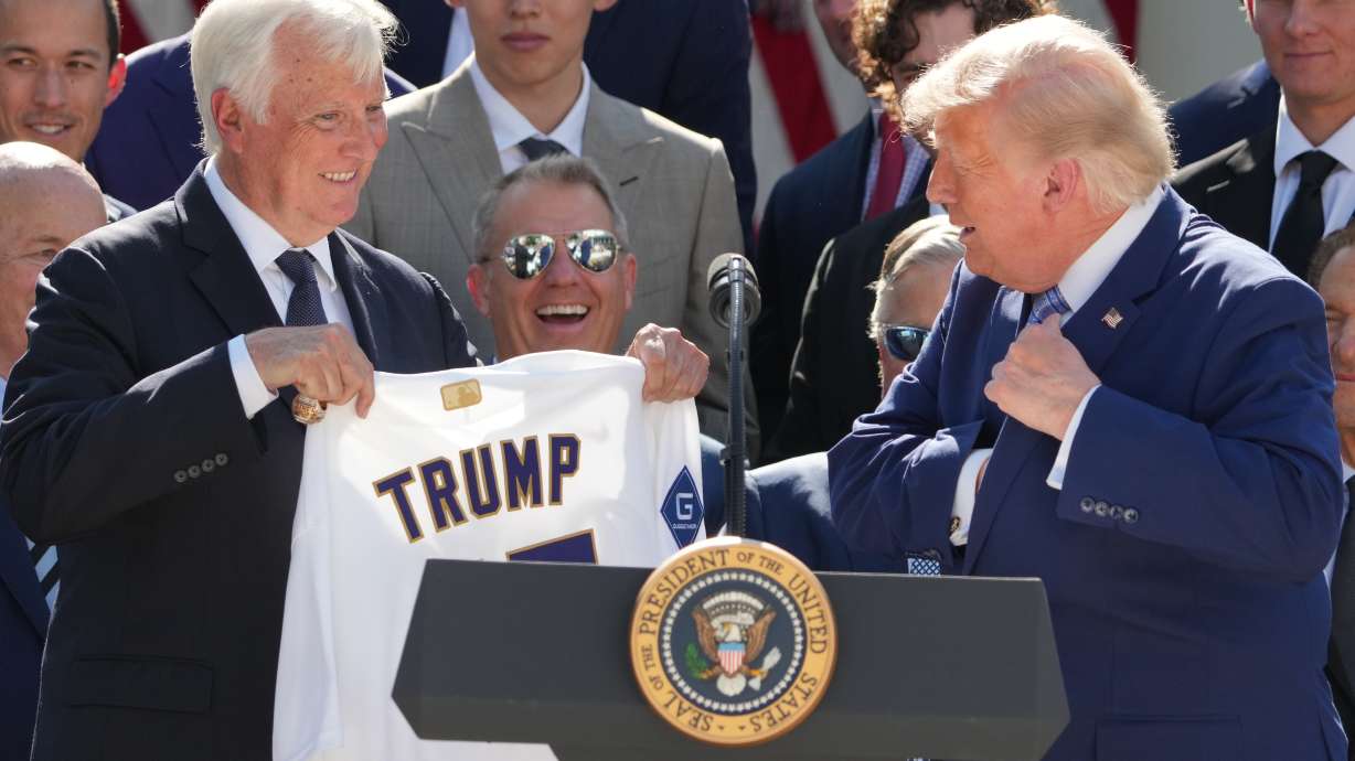 President Donald Trump puts a championship ring into his pocket as owner Mark Walter presents him with a jersey during an event to honor the 2025 World Series champions Los Angeles Dodgers in the Rose Garden of the White House, Thursday, July 23, 2026, in Washington.