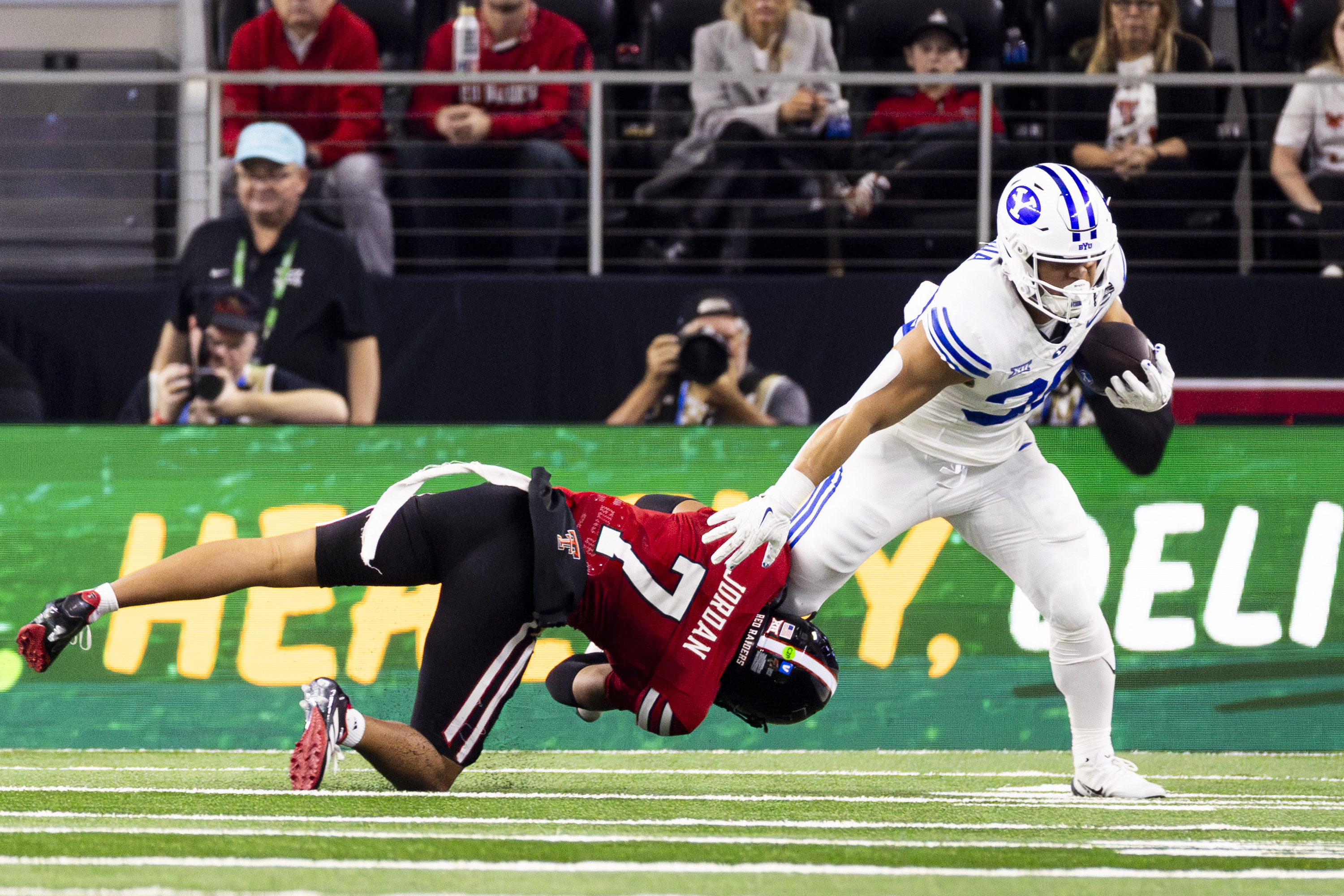 BYU running back Sione Moa (30) is downed by Texas Tech Red Raiders defensive back Brenden Jordan (7) during the Big 12 championship game held at AT&T Stadium in Arlington, Texas, on Saturday, Dec. 6, 2025.