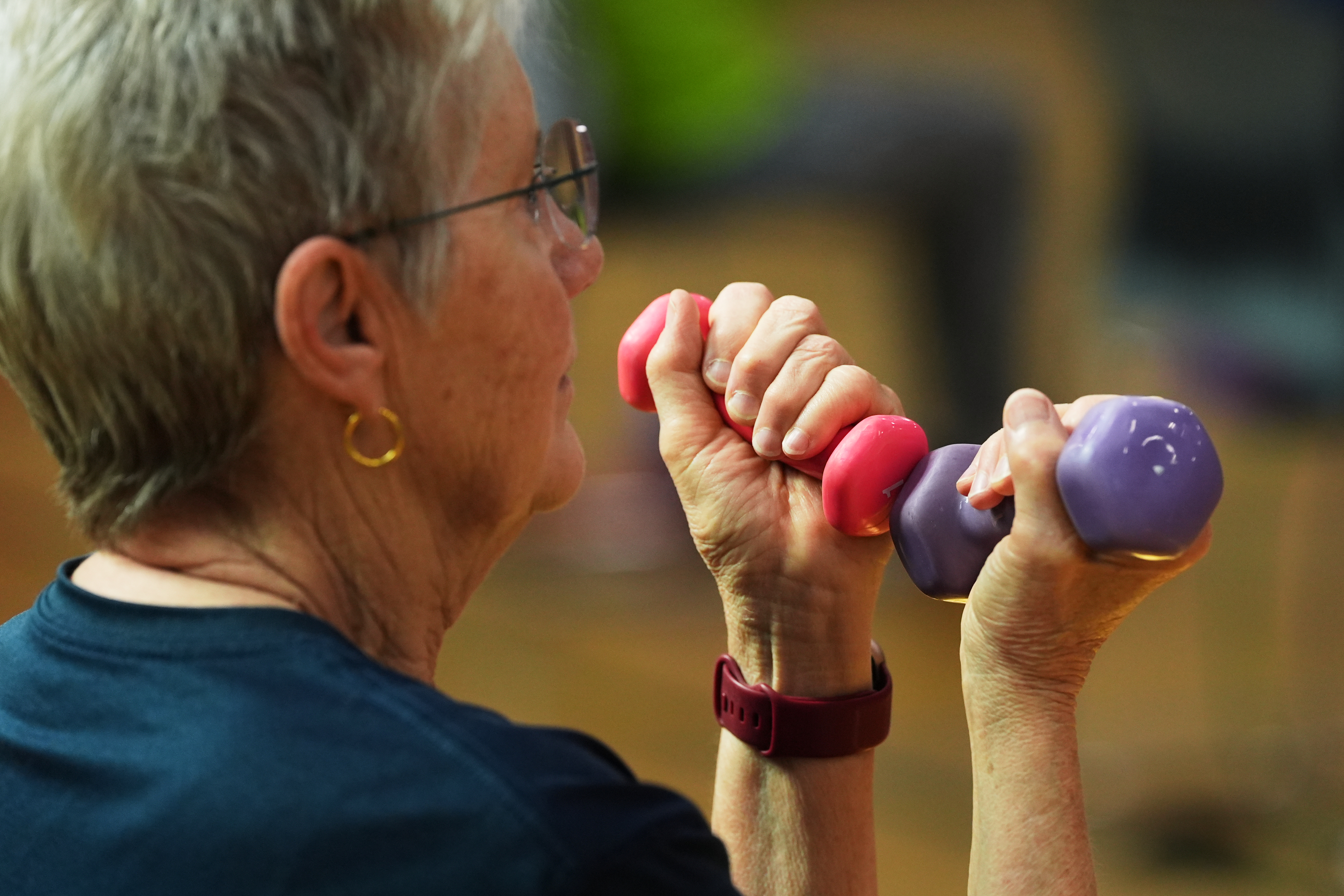 FILE - A participant uses light weights during a class for older adults at the Dale Turner Family YMCA in Shoreline, Wash., April 30, 2026. 