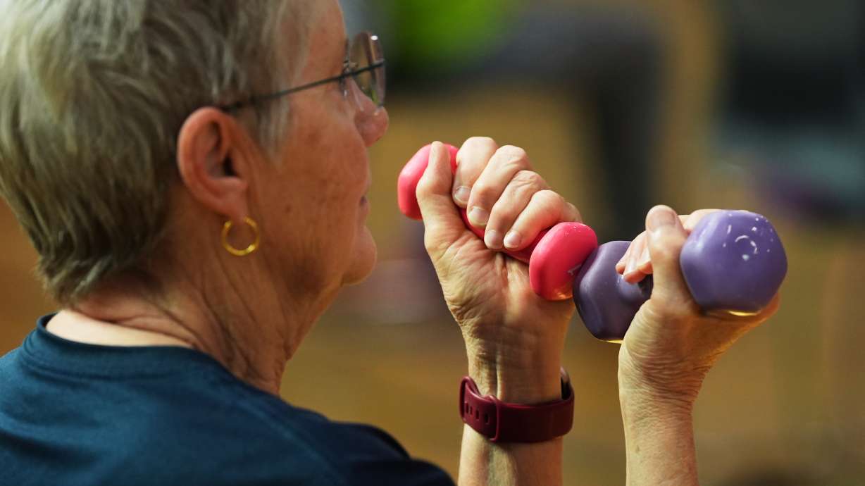 FILE - A participant uses light weights during a class for older adults at the Dale Turner Family YMCA in Shoreline, Wash., April 30, 2026.