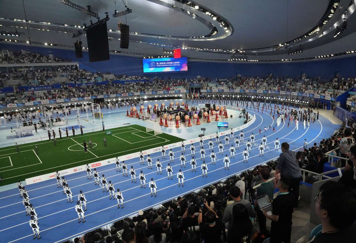 Spectator looking robots perform during the opening ceremony of the World Humanoid Robot Games in Beijing, Saturday.