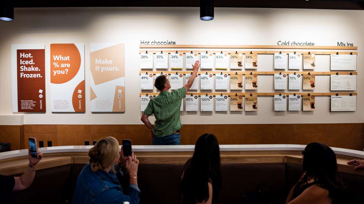 Jens Knoop, founder of Knoop, center, speaks to the press at a media event at Knoops Drinking Chocolate in Salt Lake City on Tuesday. Knoops, the first of the European chain's U.S. stores, opened on Saturday.
