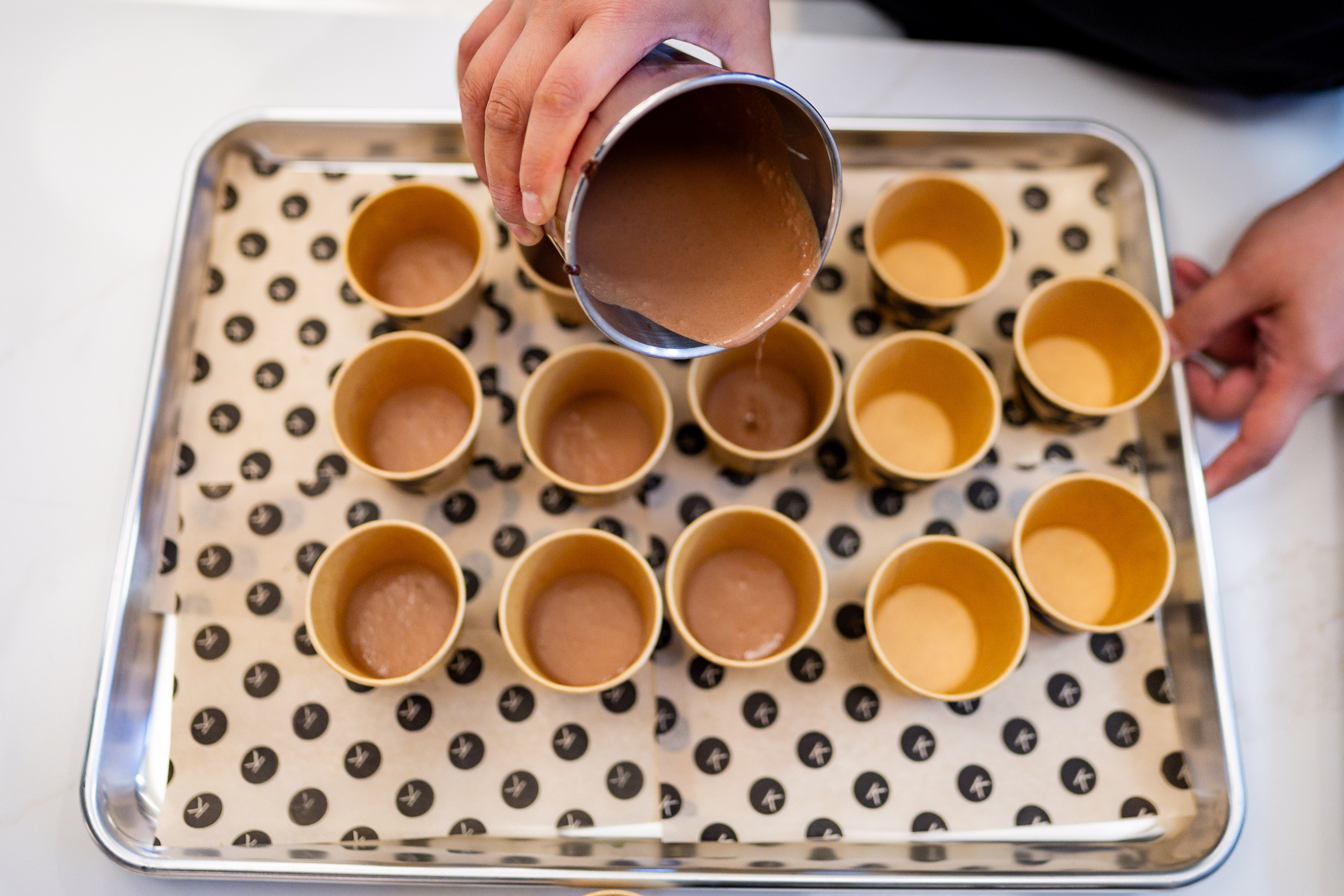 Jess, no last name given, project manager at Knoops, makes drinking chocolate for a media event at Knoops Drinking Chocolate in Salt Lake City on Tuesday. Knoops, the first of the European chain's U.S. stores, opened on Saturday.