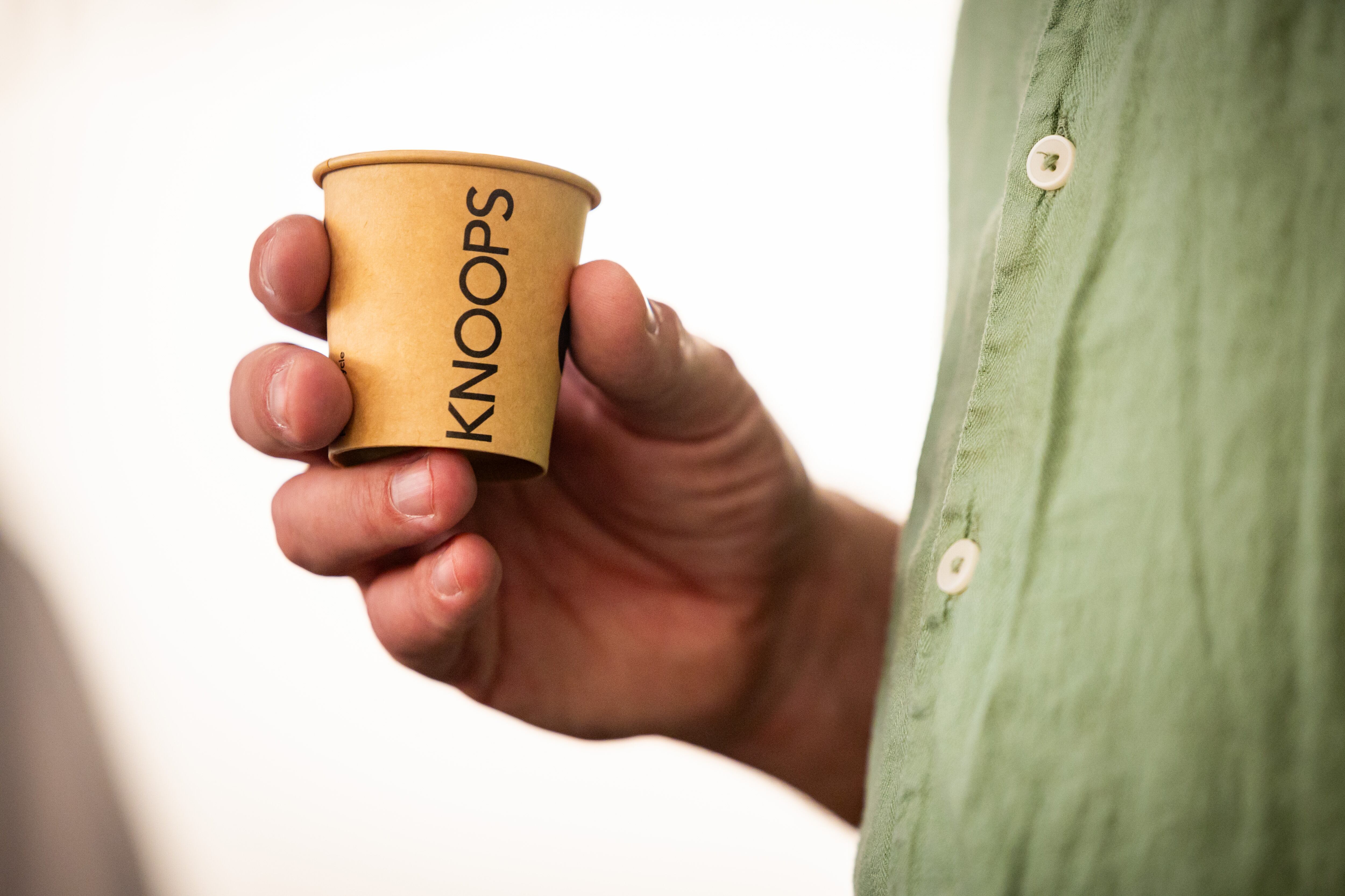 Jens Knoop, founder of Knoop, center, holds a sample of drinking chocolate while talking to the press at a media event at Knoops Drinking Chocolate in Salt Lake City on Tuesday. Knoops, the first of the European chain's U.S. stores, opened on Saturday.