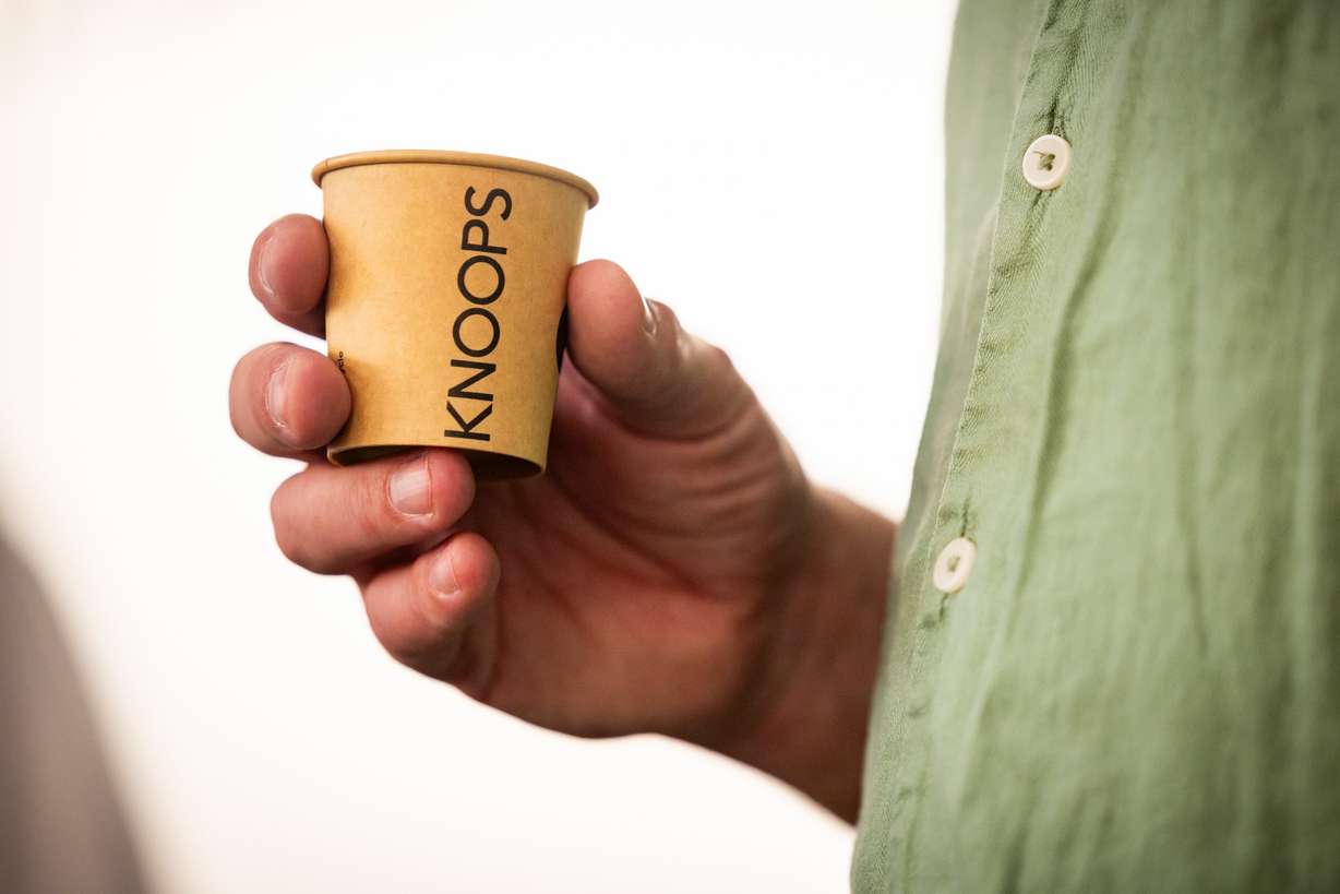 Jens Knoop, founder of Knoop, center, holds a sample of drinking chocolate while talking to the press at a media event at Knoops Drinking Chocolate in Salt Lake City on Tuesday. Knoops, the first of the European chain's U.S. stores, opened on Saturday.