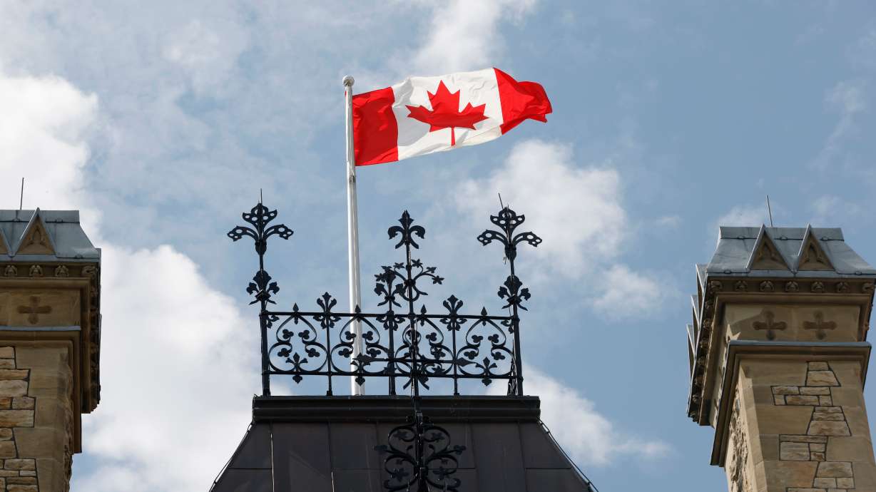 A Canadian flag flies on Parliament Hill in Ottawa on Saturday. After trade negotiations crumbled at the eleventh hour, U.S. President Donald Trump's 50% tariffs on scores of Canadian imports kicked in Saturday.