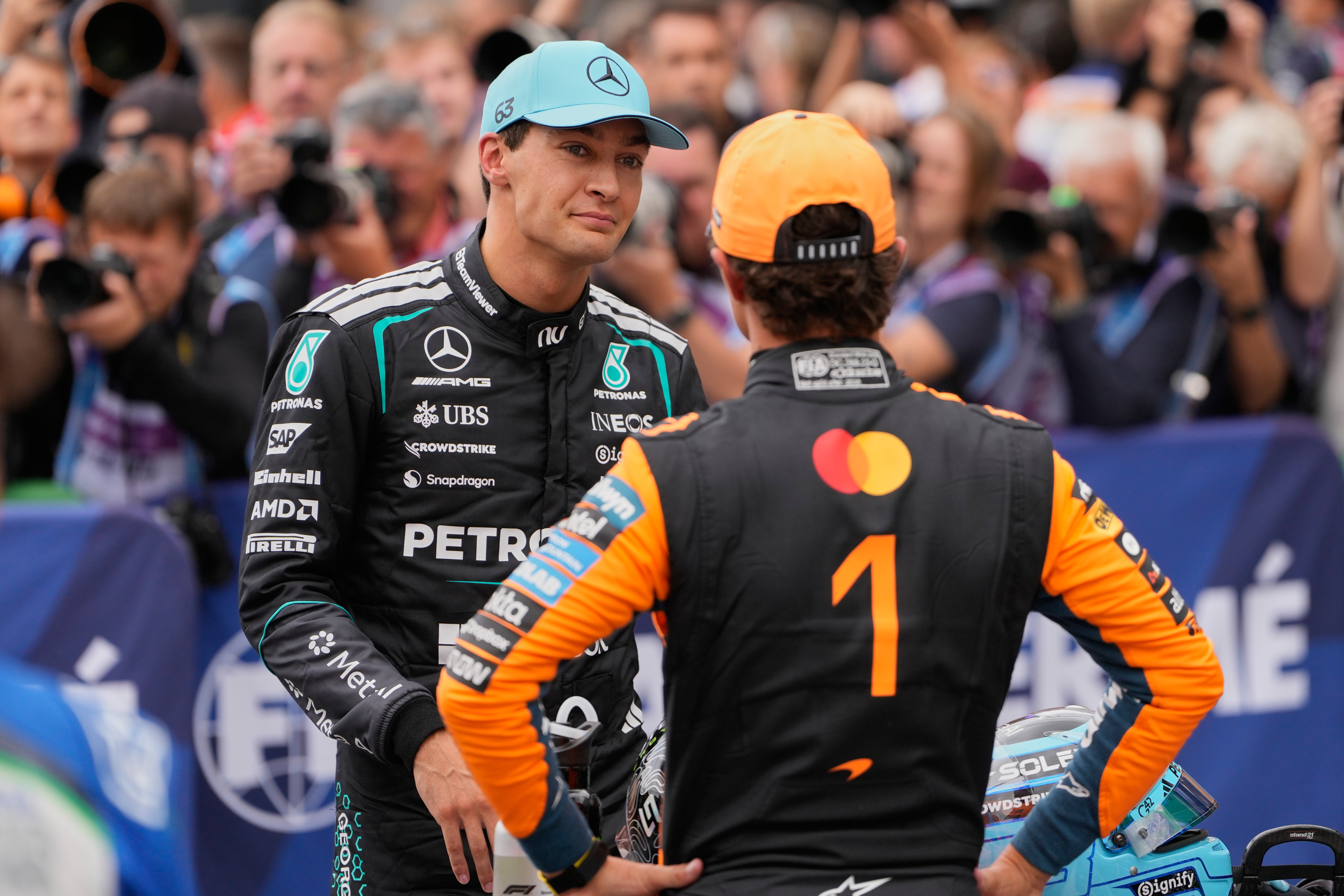 Mercedes driver George Russell of Britain, left, atlks to McLaren driver Lando Norris of Britain after the qualifying for the Formula One Dutch Grand Prix in Zandvoort , Netherlands, Saturday, Aug. 22, 2026. 