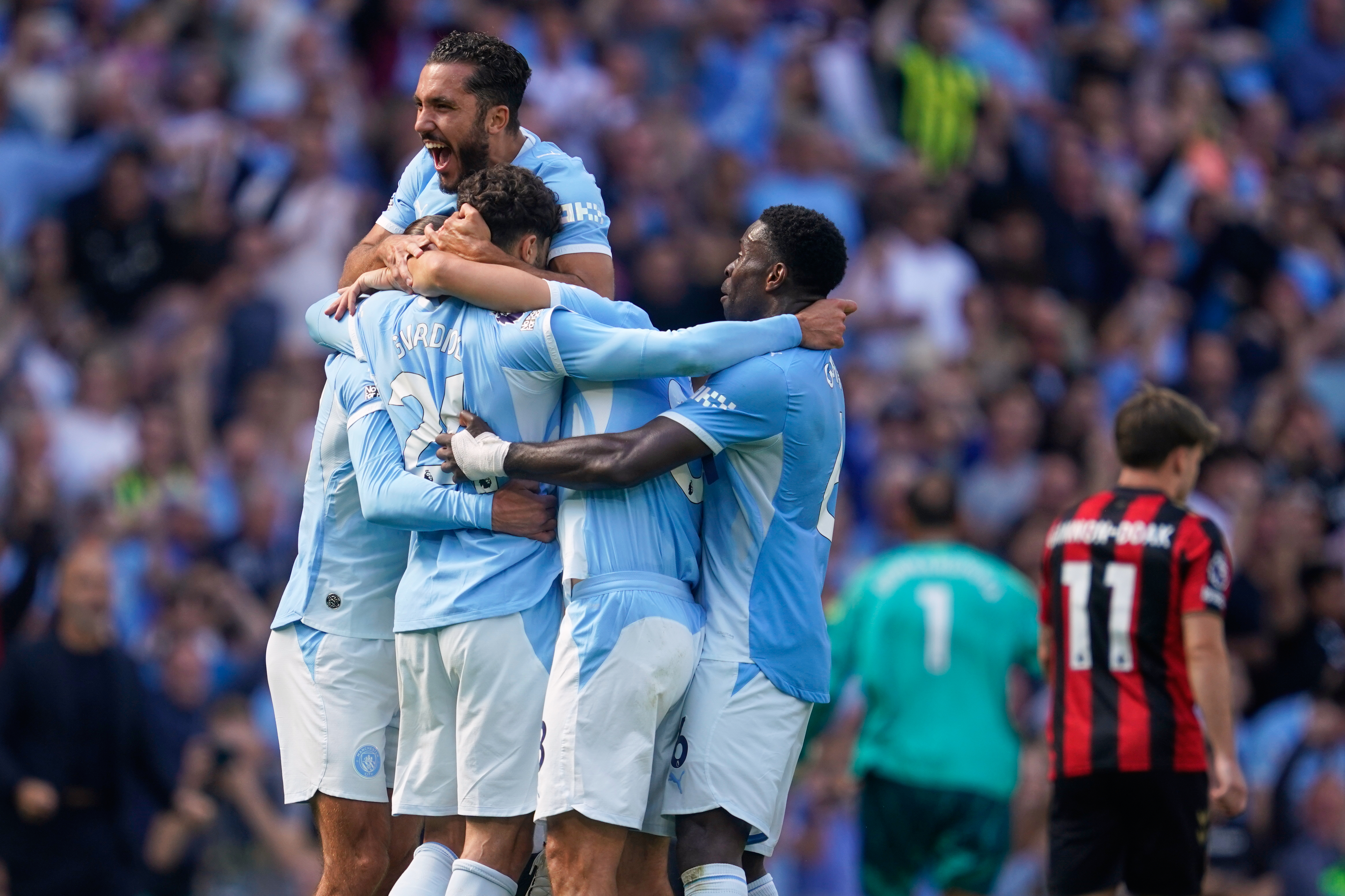 Manchester City's Josko Gvardiol (24) celebrates with teammates after scoring his side's second goal during the English Premier League soccer match between Manchester City and Bournemouth in Manchester, England, Sunday, Aug. 23, 2026. 