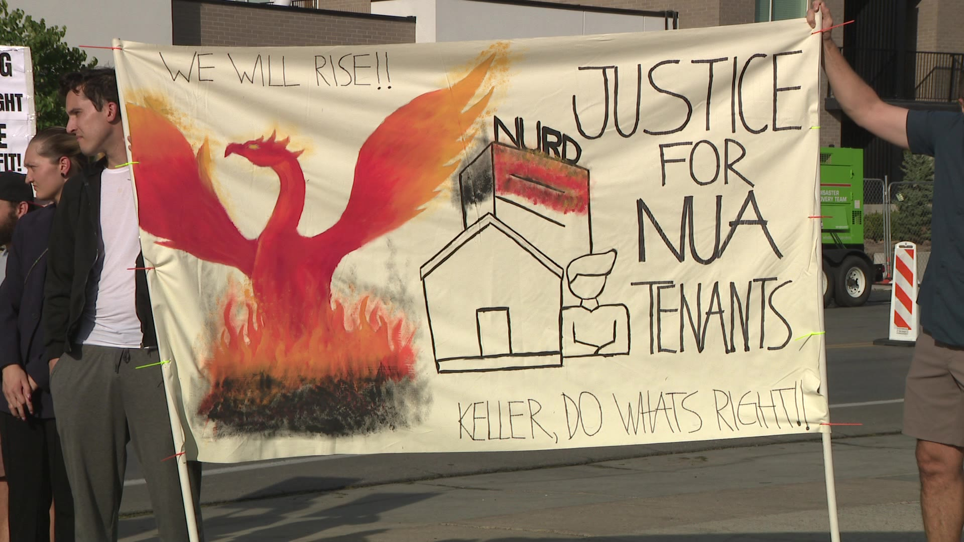 Tenants of a Midvale apartment complex displaced after a devastating July 31 blaze demonstrated at the site on Saturday, pressing for answers and help. The photo shows one of the signs held by demonstrators.