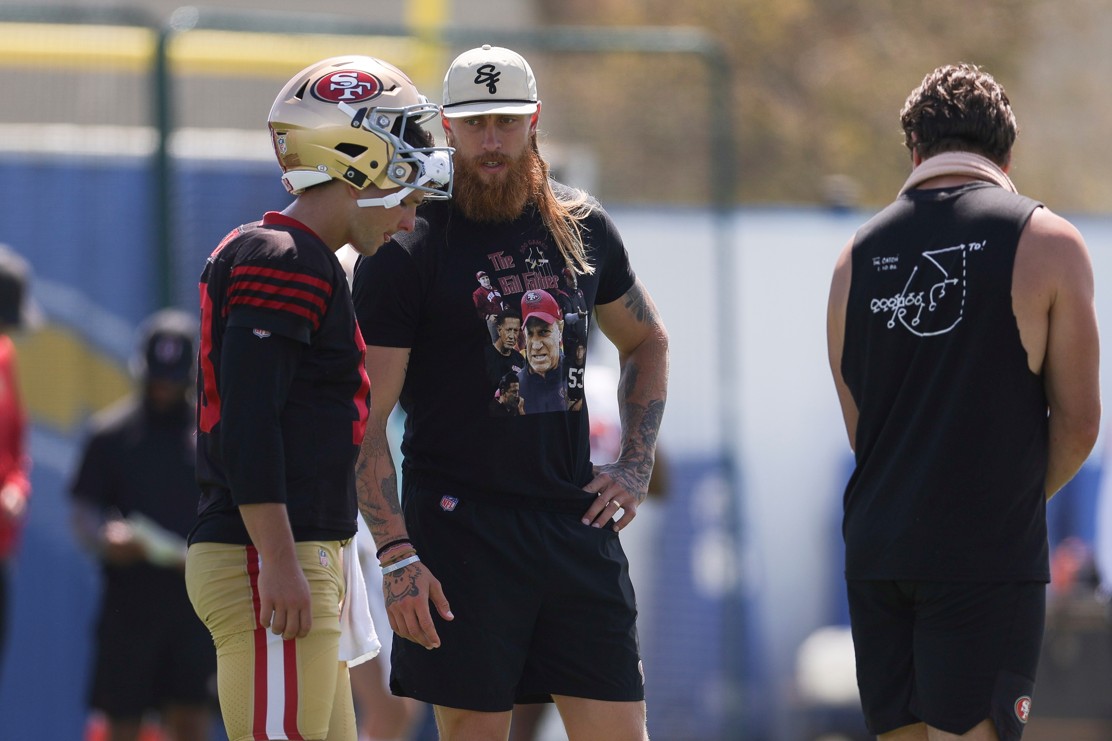 San Francisco 49ers quarterback Brock Purdy (13) talks with tight end George Kittle during a joint NFL football practice with the Los Angeles Chargers, Tuesday, Aug. 18, 2026, in El Segundo, Calif. 