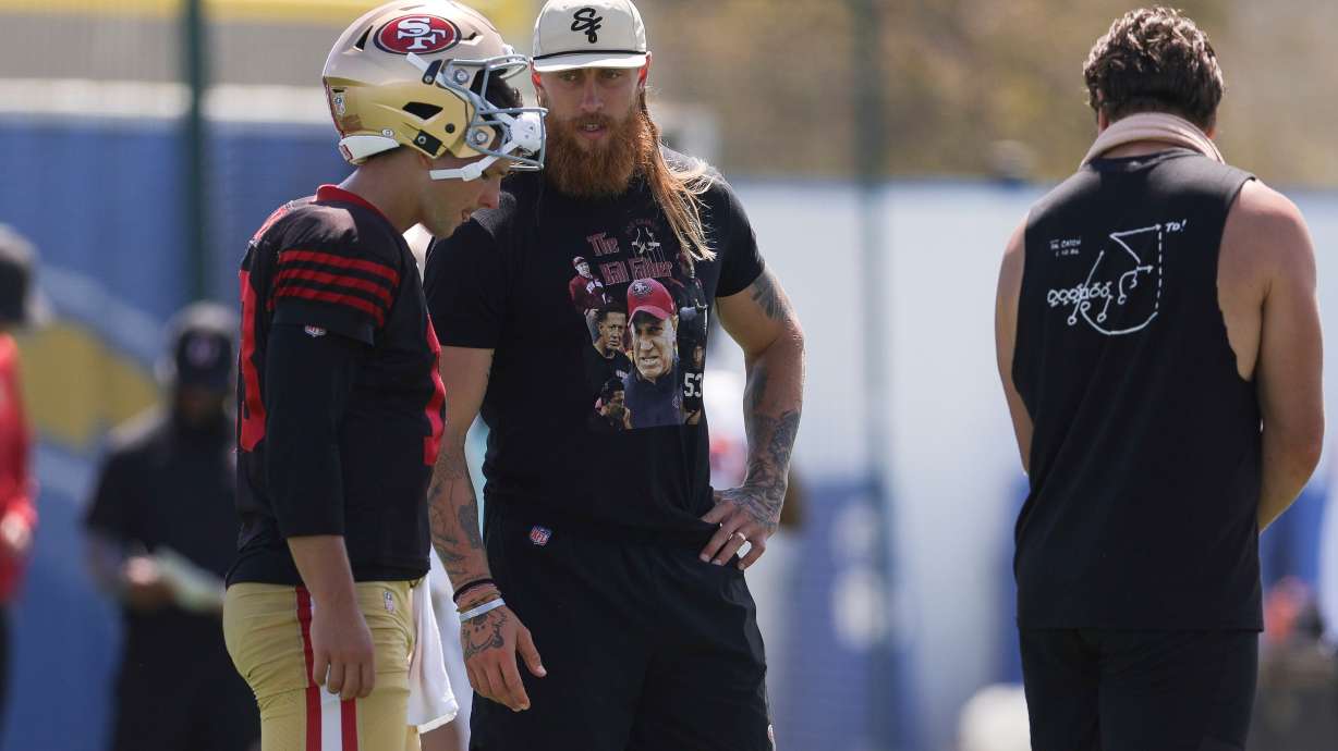 San Francisco 49ers quarterback Brock Purdy (13) talks with tight end George Kittle during a joint NFL football practice with the Los Angeles Chargers, Tuesday, Aug. 18, 2026, in El Segundo, Calif.