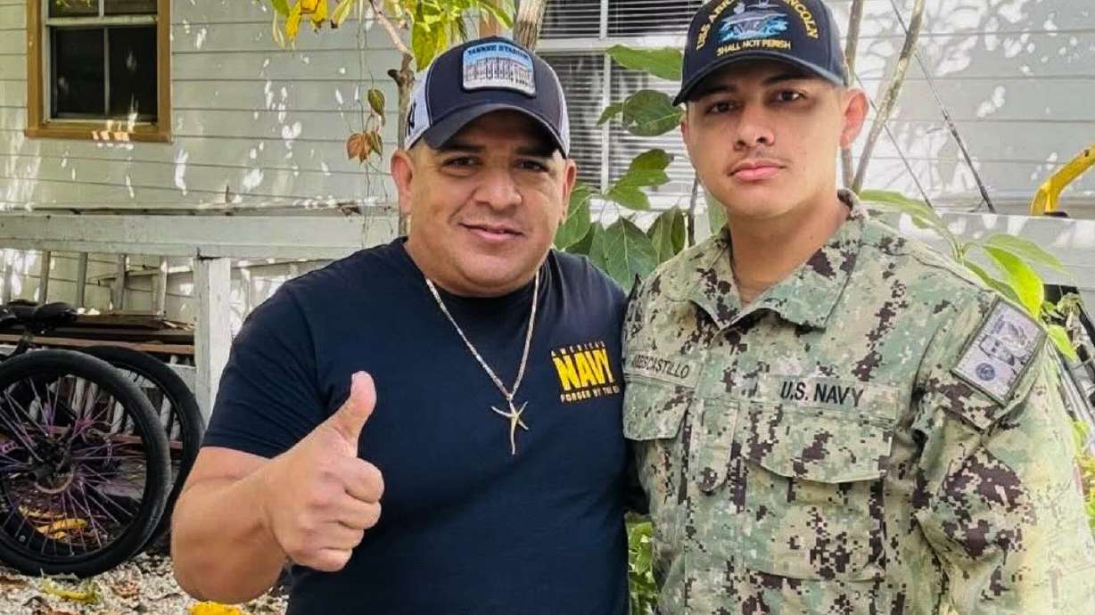 In this photo courtesy of Katherine Delgado shows her step-father Luis Manuel Aviles, left, and her brother Joshua Aviles stand outside their home in Oct. 2025, shortly before Joshua deployed on the USS Lincoln the following month in Key West, Fla.