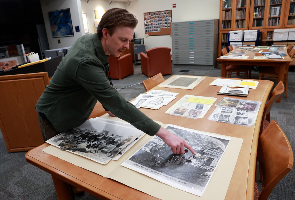 Clint Pumphrey, Utah State University Outdoor Recreation Archive curator, shows how Jansport spliced physical photos together using collage to insert their gear, such as backpacks, sleeping bags and T-shirts, into historic photos, in the Outdoor Recreation Archive in the Merrill-Cazier Library in Logan on Thursday, Aug. 6, 2026.