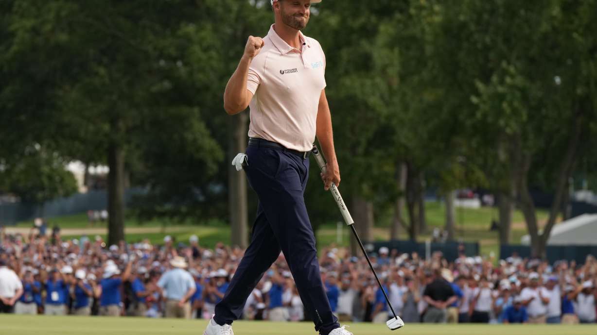 Wyndham Clark celebrates winning on the 18th green in the final round of the BMW Championship golf tournament, Sunday, Aug. 23, 2026, in St. Louis.