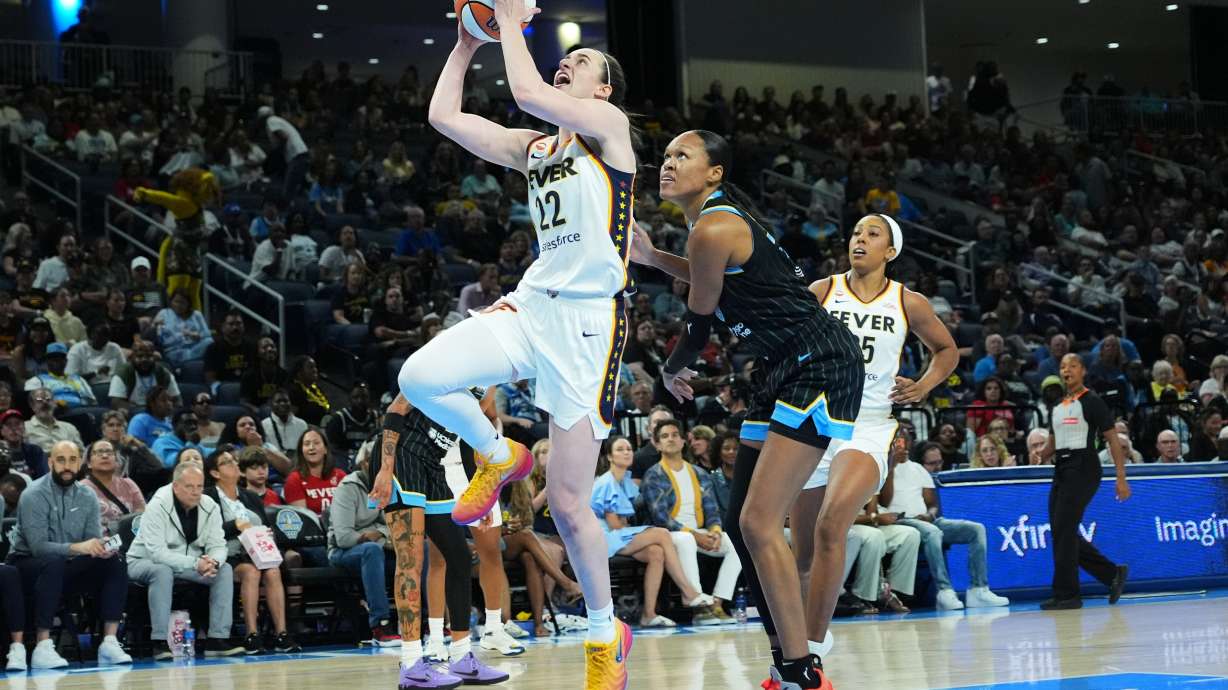 Indiana Fever guard Caitlin Clark, center left, drives to the basket past Chicago Sky forward/center Azura Stevens, center right, during the first half of a WNBA basketball game Sunday, Aug. 23, 2026, in Chicago.