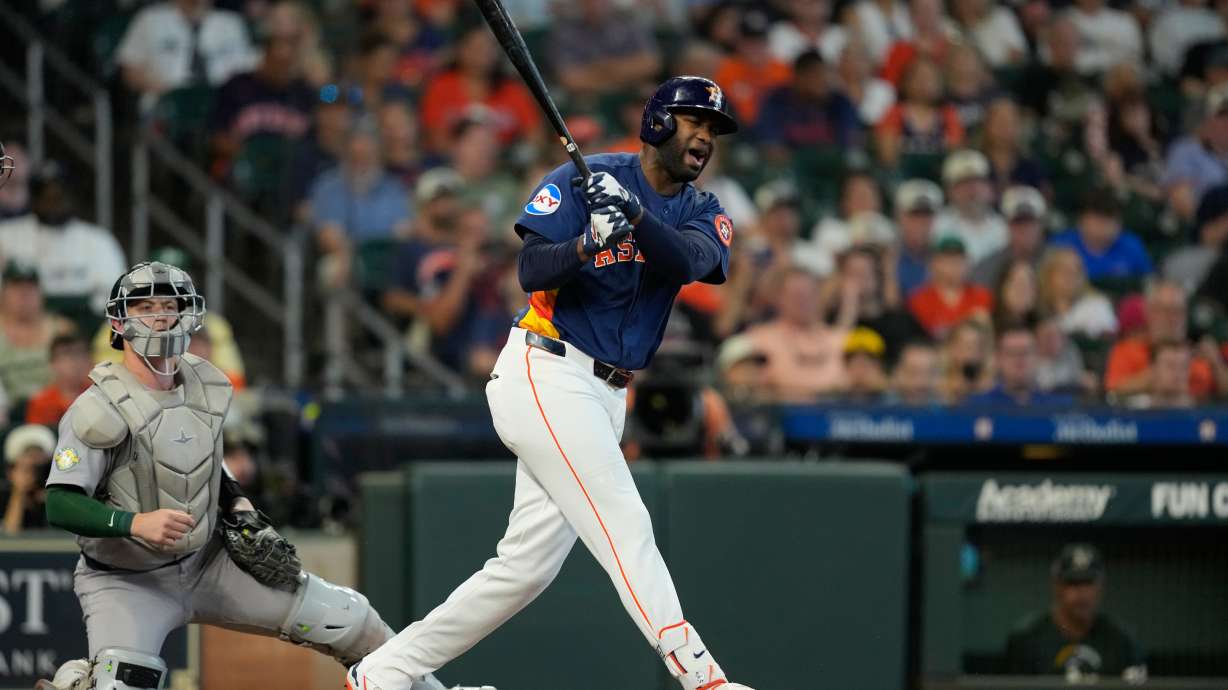 Houston Astros' Yordan Alvarez, right, reacts after fouling a pitch off his foot in front of Athletics catcher Brian Serven during the fourth inning of a baseball game Sunday, Aug. 23, 2026, in Houston.
