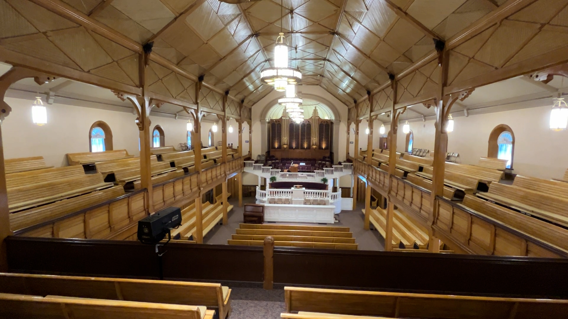 The interior of the historic Paris Tabernacle features detailed woodwork, a 1928 pipe organ with 629 pipes and stained-glass windows. The tabernacle, built between 1884 and 1888, continues to welcome visitors from around the world.