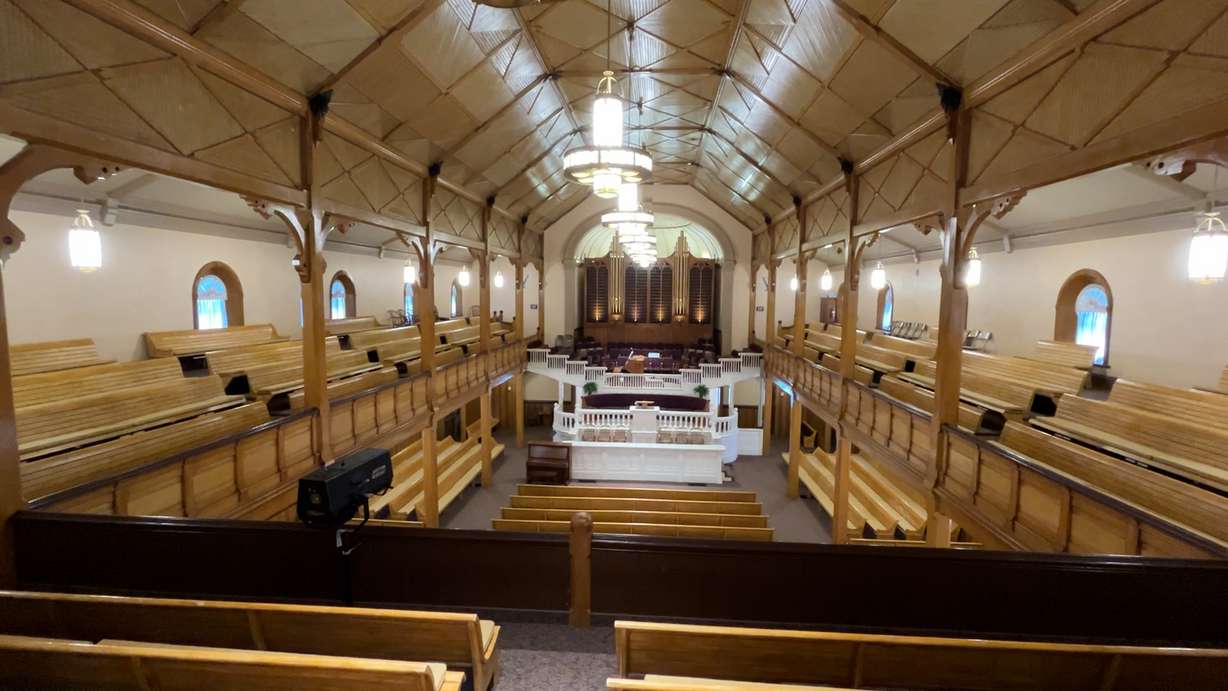 The interior of the historic Paris Tabernacle features detailed woodwork, a 1928 pipe organ with 629 pipes and stained-glass windows. The tabernacle, built between 1884 and 1888, continues to welcome visitors from around the world.