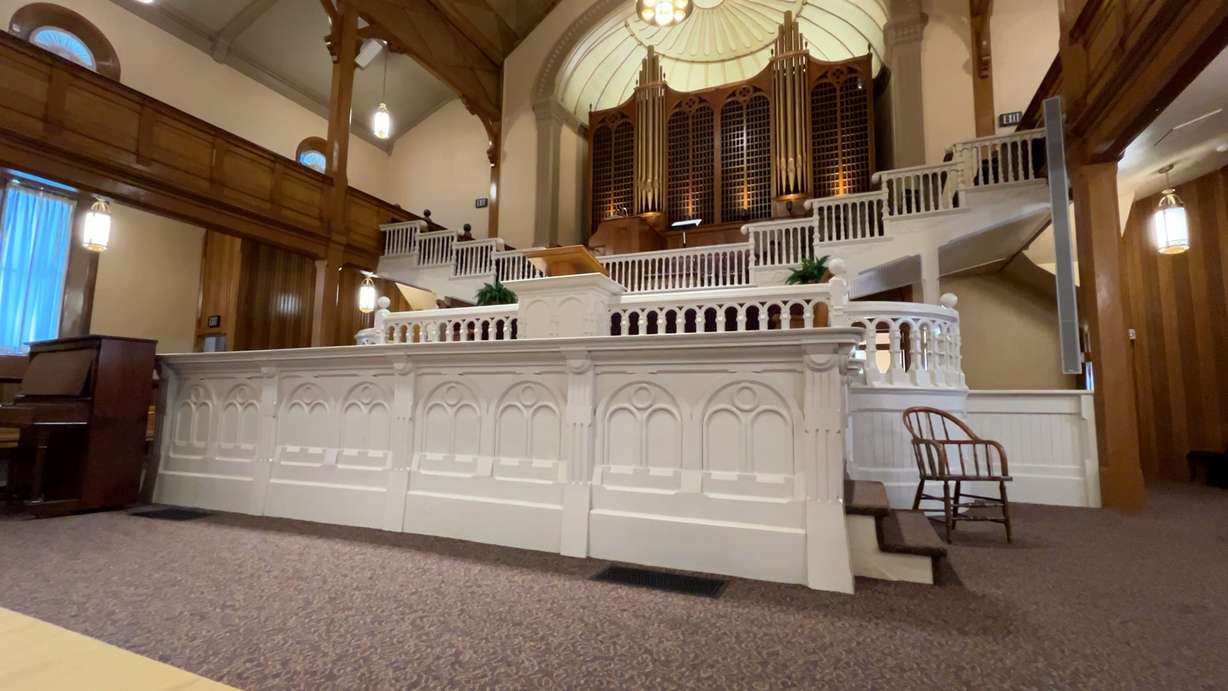 The interior of the historic Paris Tabernacle features detailed woodwork, a 1928 pipe organ with 629 pipes and stained-glass windows. The tabernacle, built between 1884 and 1888, continues to welcome visitors from around the world.