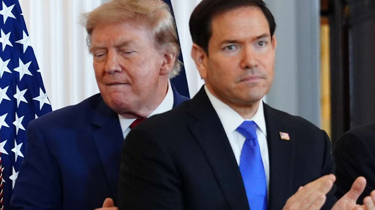 President Donald Trump walks past Secretary of State Marco Rubio as he arrives for a roundtable on the American mining industry, Friday, Aug. 7, 2026, at the State Department in Washington.