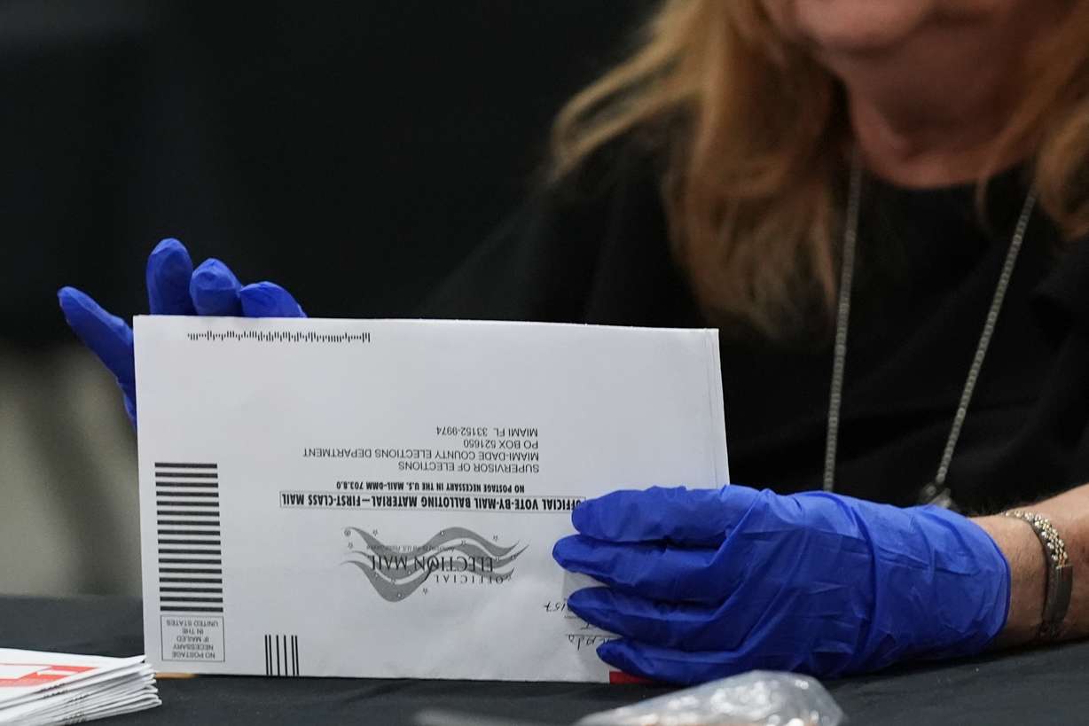 An election worker sorts vote-by-mail ballots at the Miami-Dade County Supervisor of Elections Office for the Florida primary election in Doral, Fla., Tuesday, Aug. 18.