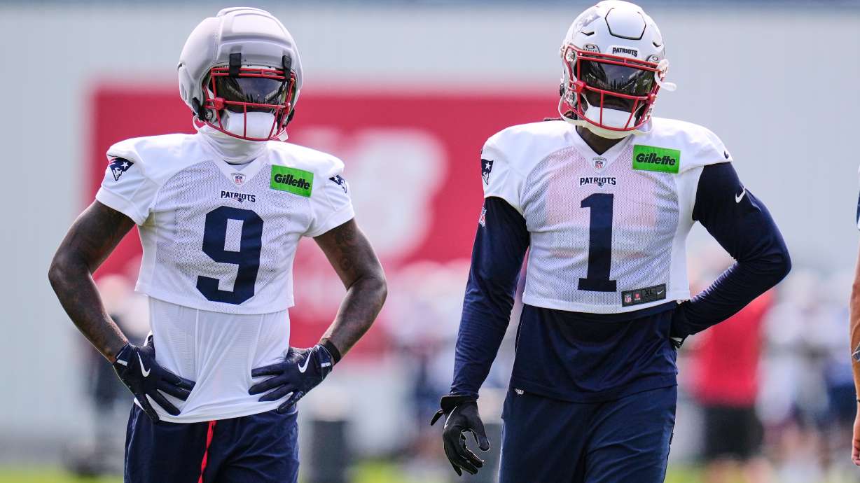 New England Patriots wide receivers A.J. Brown (1) and Kayshon Boutte (9) wait their turn on a drill during the team's NFL football training camp, Monday, Aug. 10, 2026, in Foxborough, Mass.