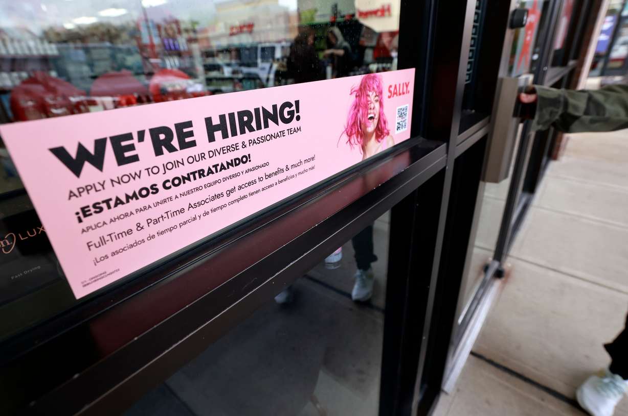 A “We’re Hiring!” sign is posted at Sally Beauty in Salt Lake City on Nov. 20, 2025.
