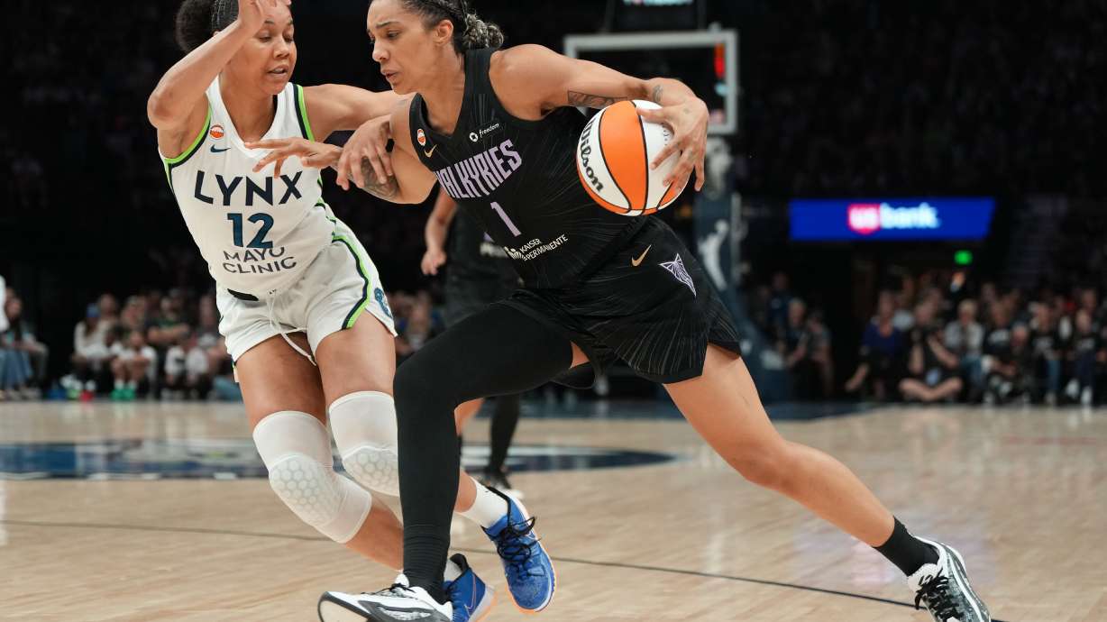 Golden State Valkyries forward Gabby Williams (1) works toward the basket as Minnesota Lynx forward Nia Coffey (12) defends during the second half of a WNBA basketball game Monday, Aug. 24, 2026, in Minneapolis.