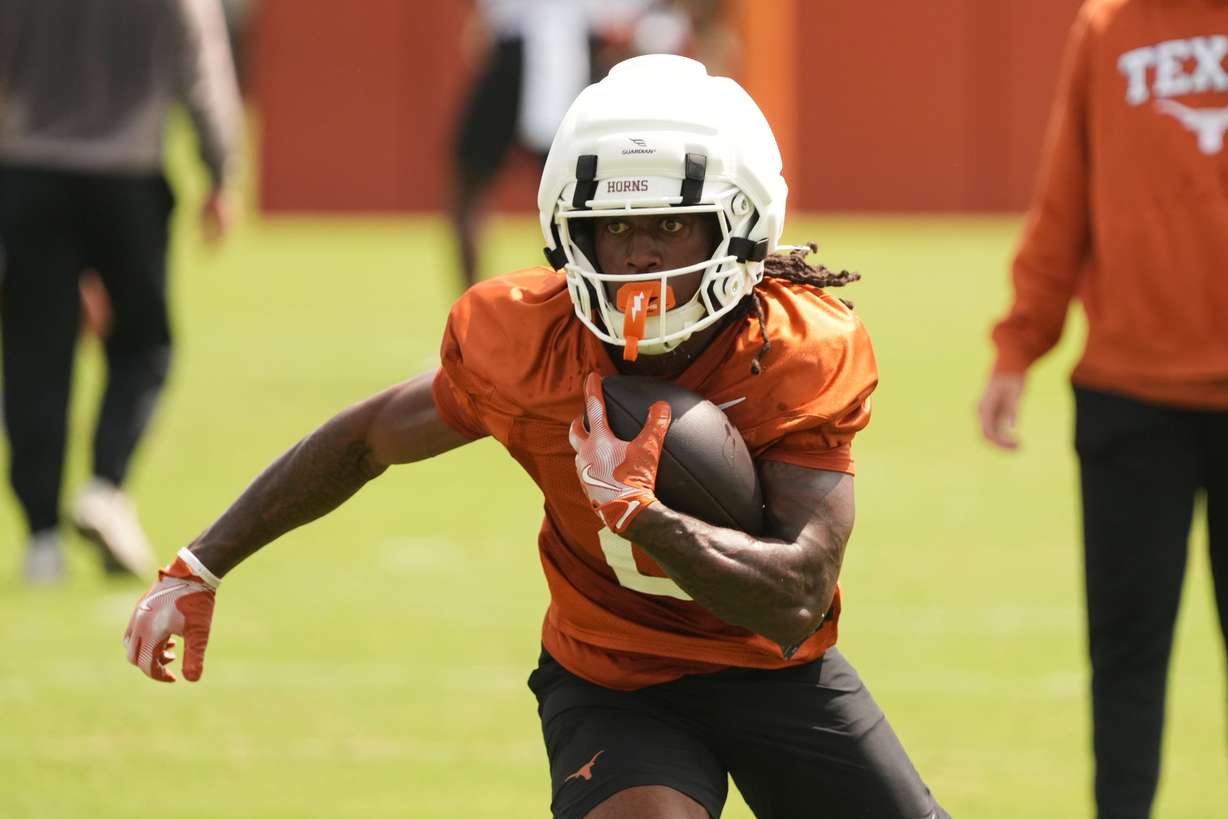 Texas running back Hollywood Smothers (2) runs a drill during an NCAA college preseason football camp in Austin, Texas, Aug. 5.