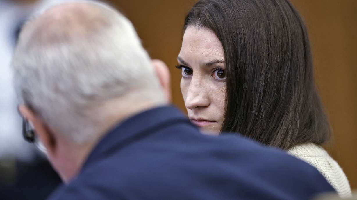Defendant Lindsay Clancy talks with her lawyer Kevin Reddington. during her murder trial at Plymouth Superior Court, Monday in Plymouth, Mass.