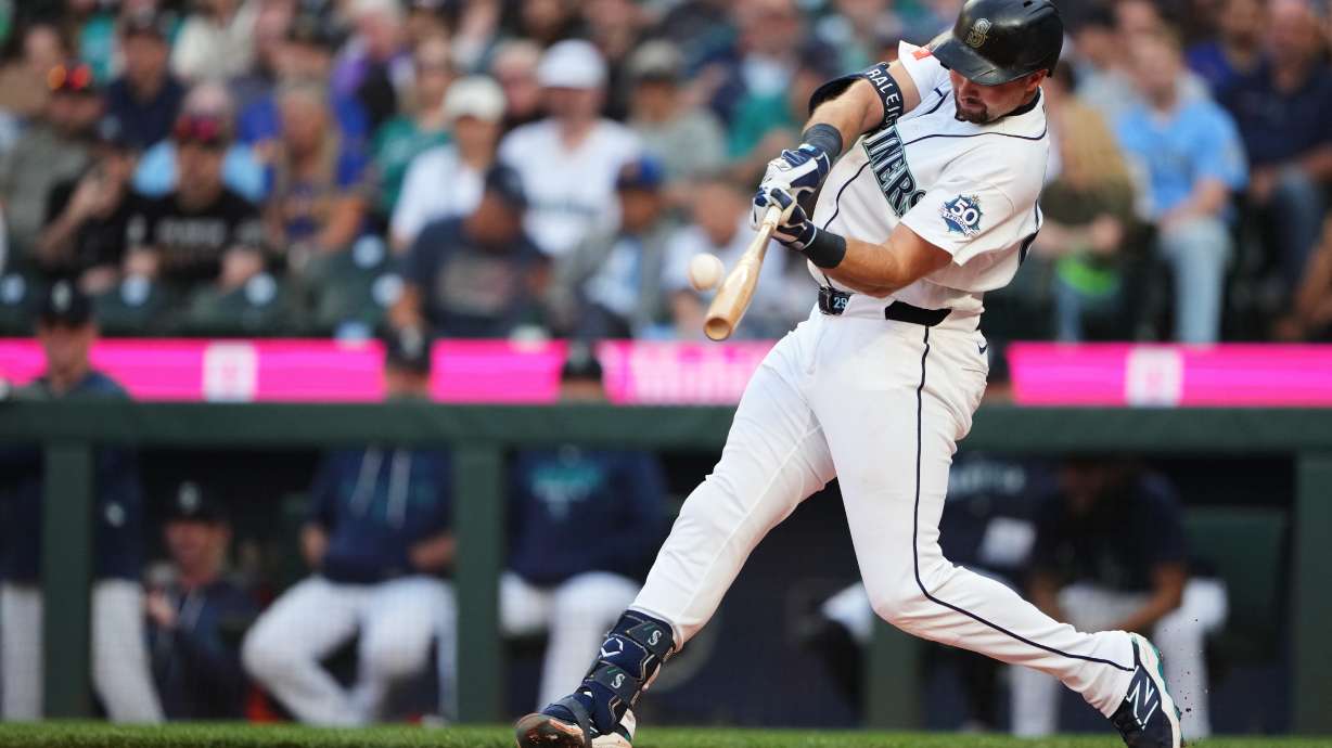Seattle Mariners' Cal Raleigh hits a two-run home run against the Philadelphia Phillies during the first inning of a baseball game, Monday, Aug. 24, 2026, in Seattle.