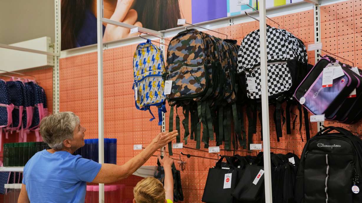 Shoppers choose a backpack at a Target store, Aug. 13, in Woodbury, Minn.