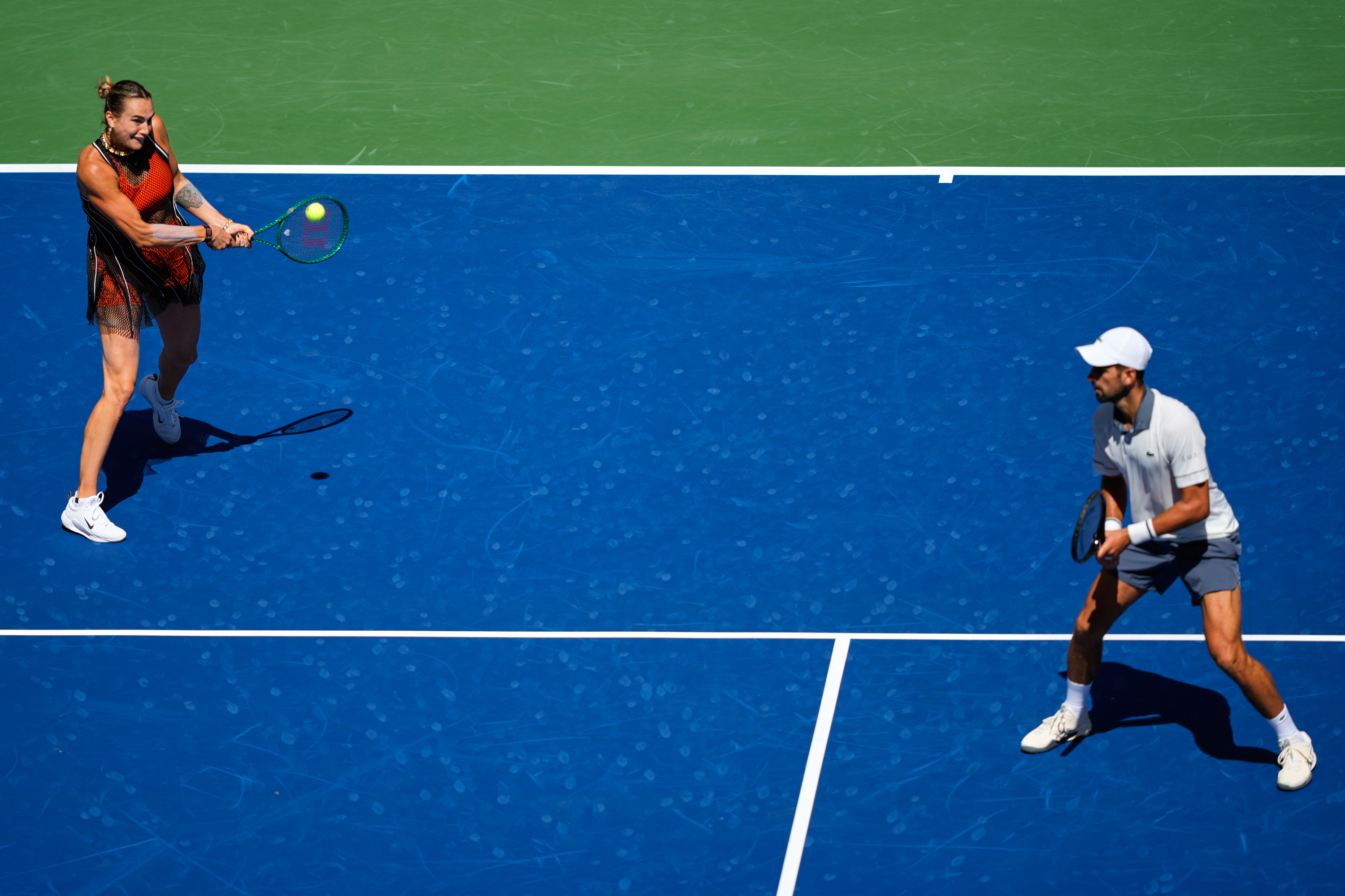 Aryna Sabalenka, of Belarus, and Novak Djokovic, of Serbia, during a mixed doubles match at the U.S. Open tennis championships, Tuesday, Aug. 25, 2026, in New York. 