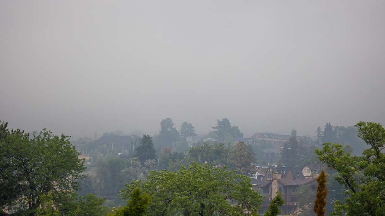 Low clouds and rain, as well as poor air quality from smoke, obscure homes in the Avenues neighborhood in Salt Lake City on Aug. 18, 2021. A Utah-led study published on Tuesday finds that wildfire smoke can cause "large bursts" of nitrogen, phosphorus and potassium to fall when it mixes with rain.