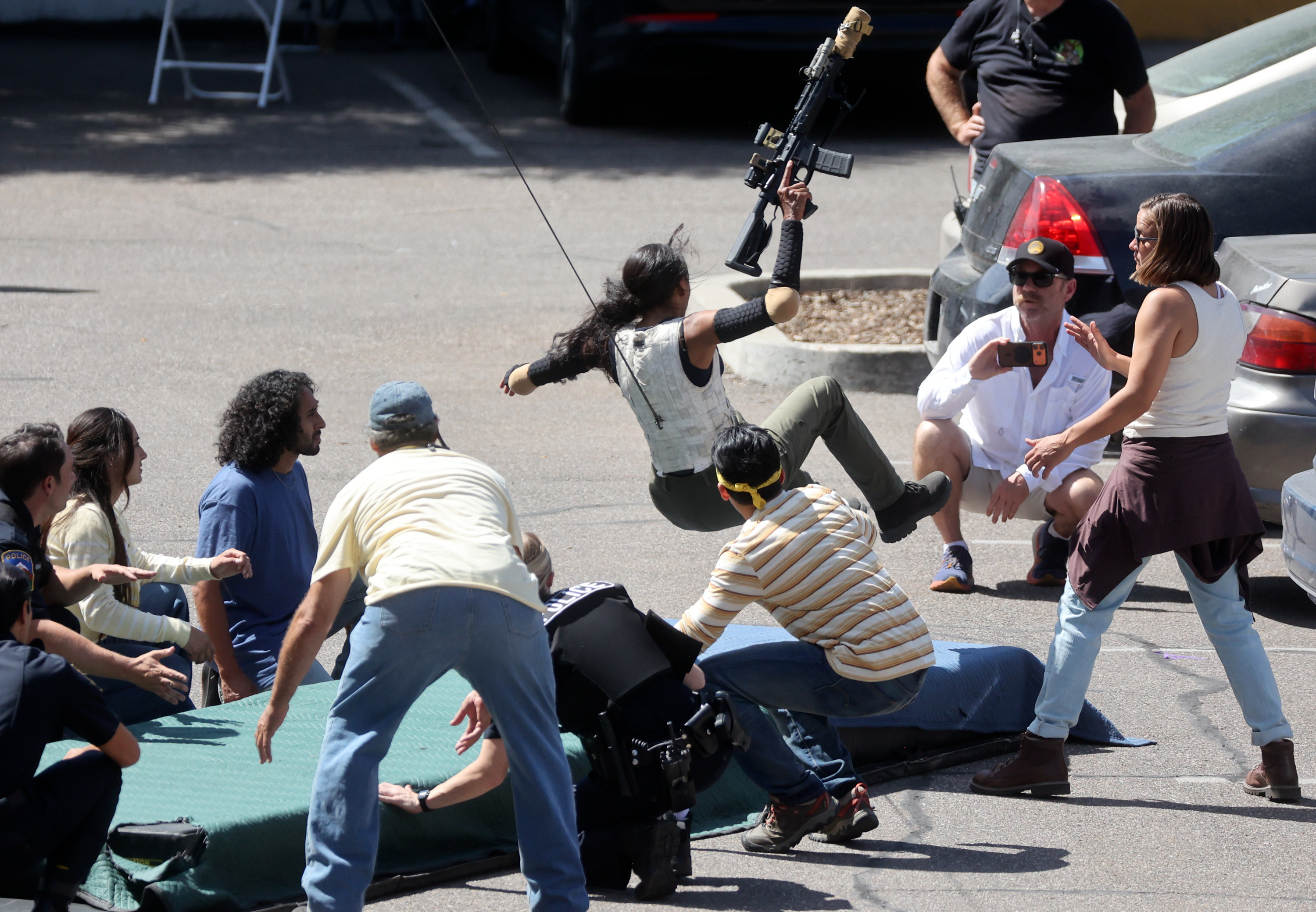 A stunt double for Ash Santos, who plays U.S. Marshal Andrea Cruz, rehearses a scene of “Marshals” while filming in Ogden on Tuesday.