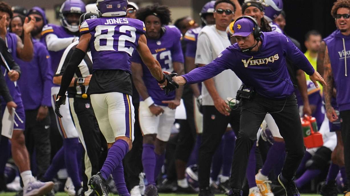 Minnesota Vikings wide receiver Jeshaun Jones (82) celebrates with head coach Kevin O'Connell after completing a 35-yard catch during the first half of an NFL preseason football game against the Baltimore Ravens, Saturday, Aug. 22, 2026, in Minneapolis.