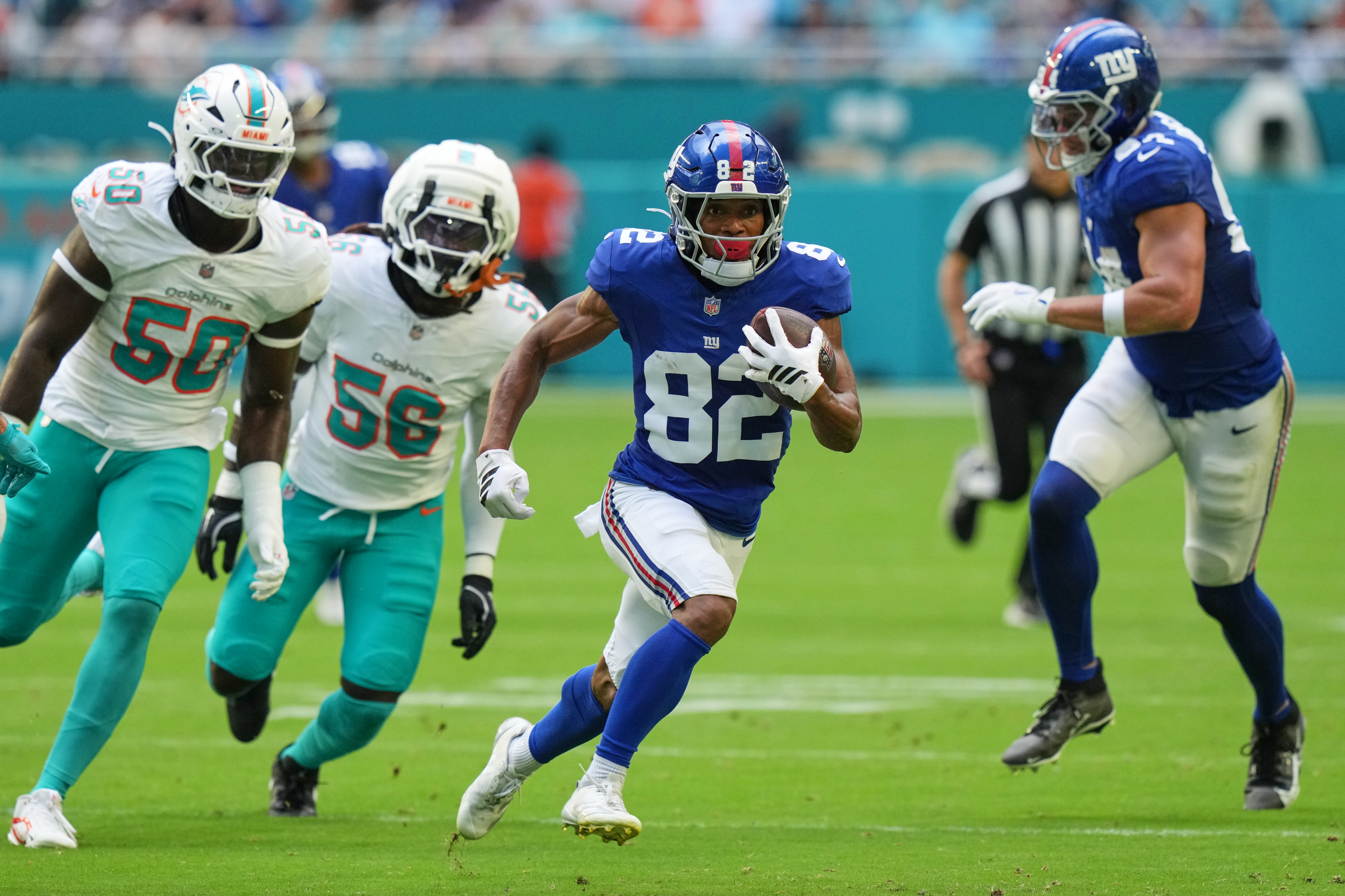 New York Giants wide receiver Calvin Austin III (82) runs the ball during the first half of a preseason NFL football game against the Miami Dolphins, Saturday, Aug. 22, 2026, in Miami Gardens, Fla. 