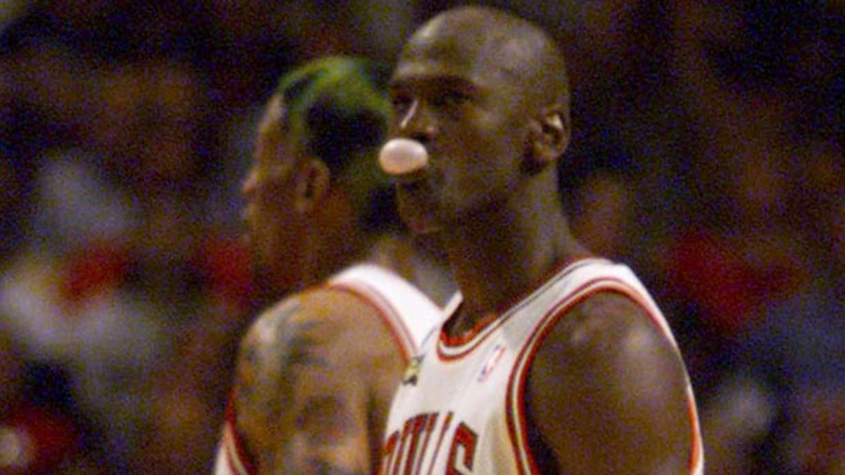 Michael Jordan blows a bubble during game 5 of the NBA Finals in Chicago, June 12, 1998. A game-worn Jordan jersey is expected to break the record for most expensive basketball jersey to ever be auctioned.