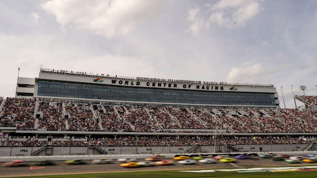 FILE - Cars move during the NASCAR Daytona 500 auto race at Daytona International Speedway, Feb. 15, 2026, in Daytona Beach, Fla.