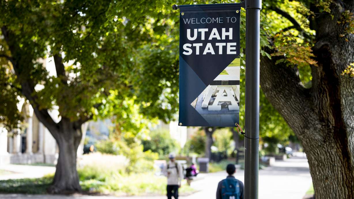 Students walk past a banner on the campus of Utah State University in Logan on Oct. 1, 2025. A newly released federal report says a Utah State University research lab was responsible for euthanizing 82 naked mole rats using an unapproved method.