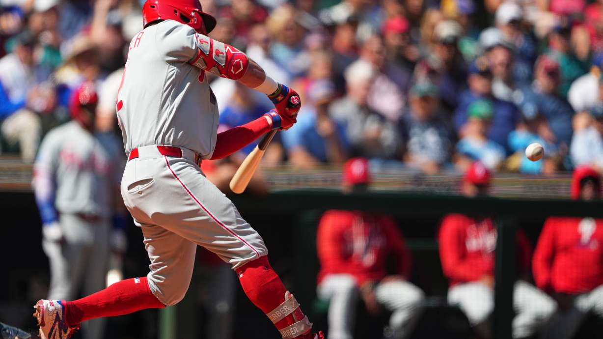 Philadelphia Phillies' Kyle Schwarber hits a three-run home run against Seattle Mariners starting pitcher Bryan Woo during the second inning of a baseball game, Wednesday, Aug. 26, 2026, in Seattle.