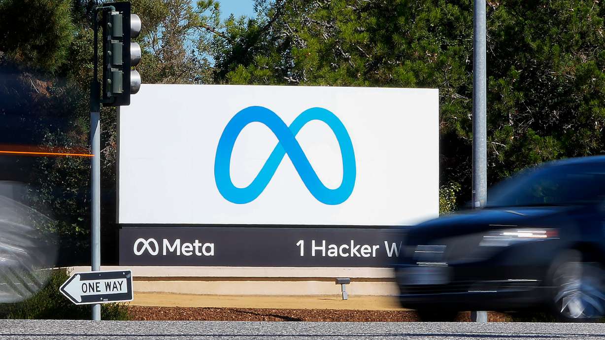 A car passes Facebook's new Meta logo on a sign at the company headquarters on Oct. 28, 2021, in Menlo Park, Calif.