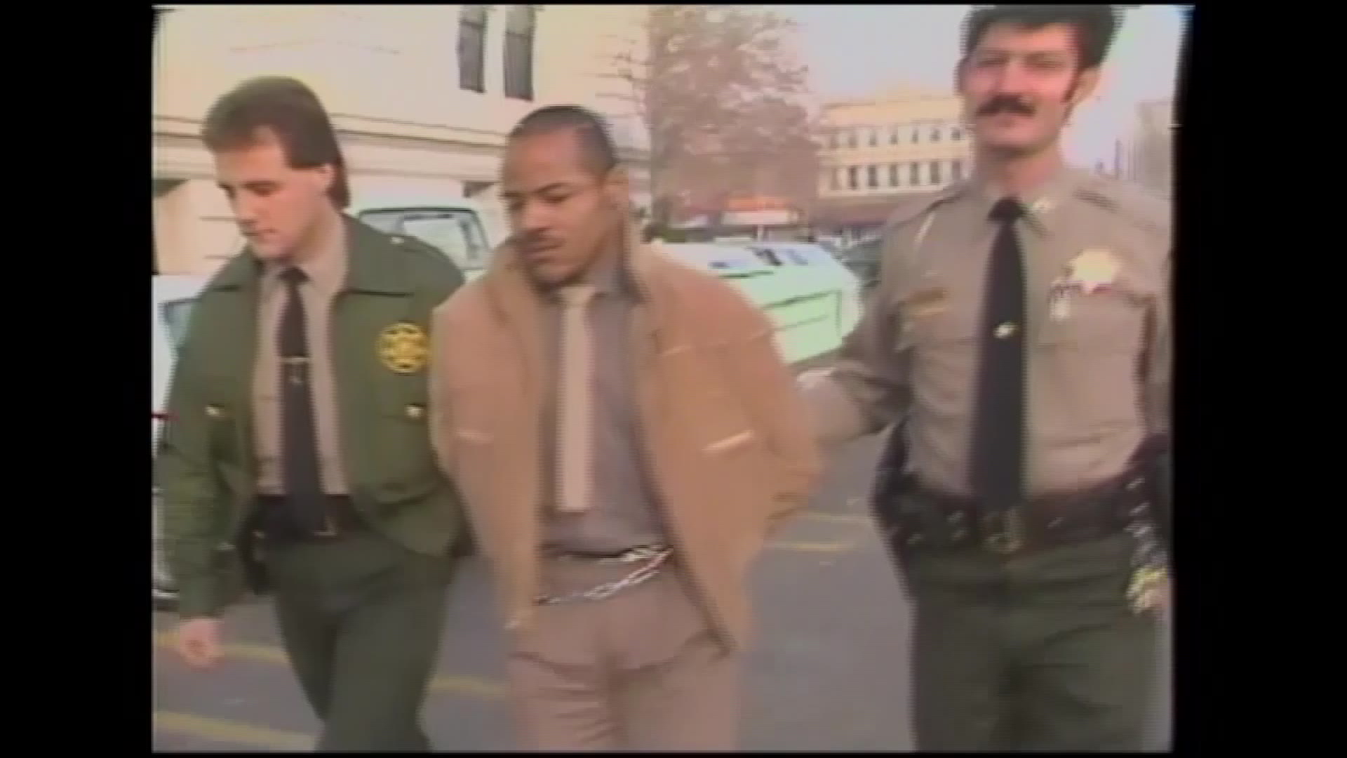A screengrab shows a moment in a piece of archived footage from the day Douglas Carter was arrested.