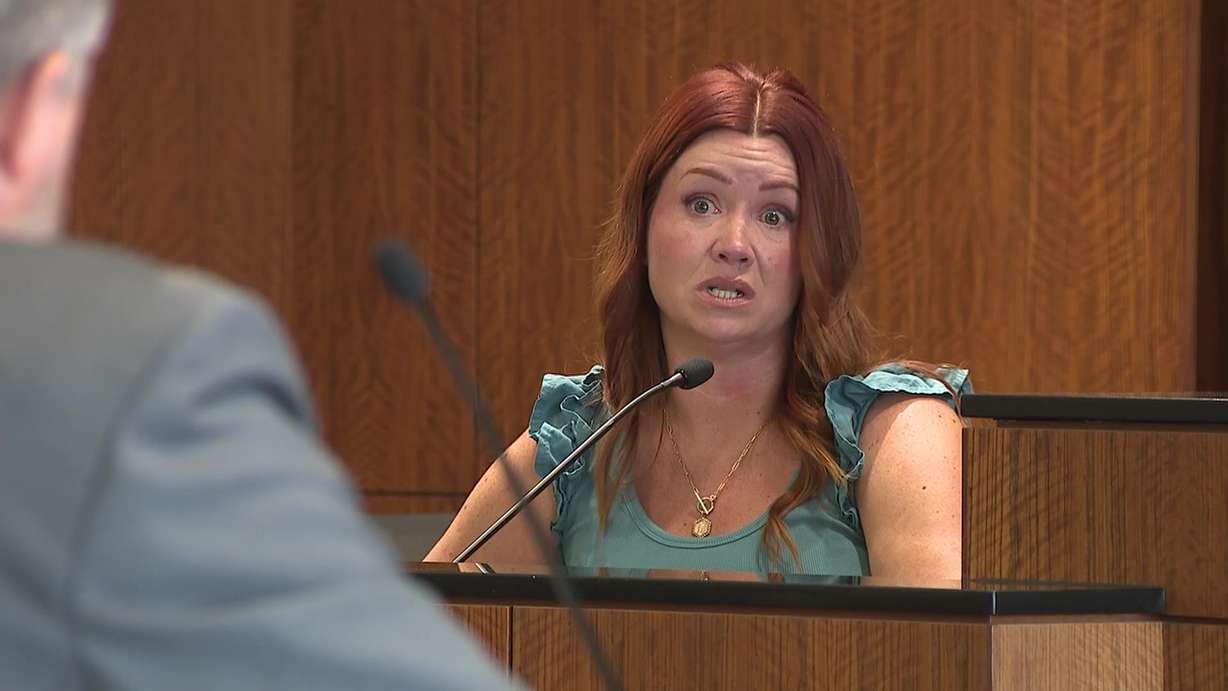 Melissa Anger is pictured on the stand in court Wednesday, speaking with defense attorney for Douglas Carter, who is her father-in-law.