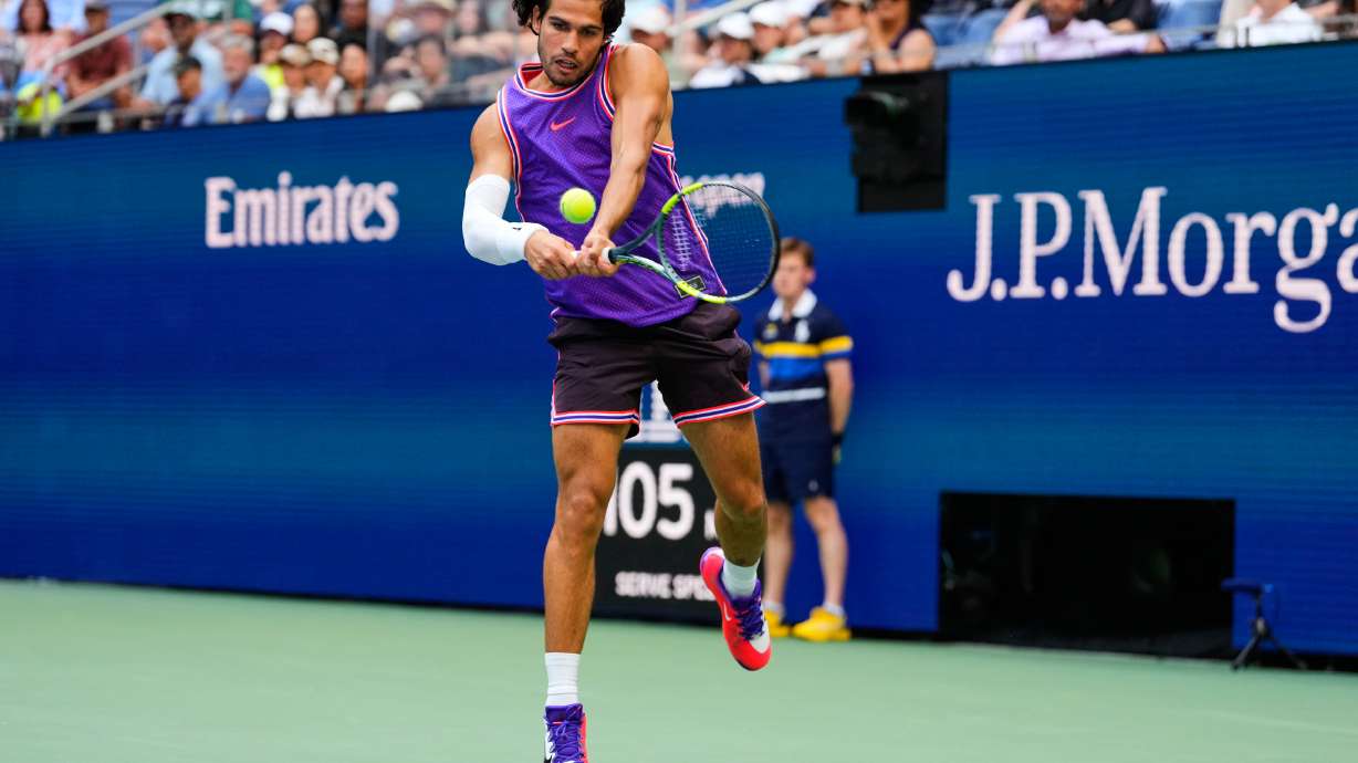 Carlos Alcaraz, of Spain, returns the ball during a mixed doubles match at the U.S. Open tennis championships, Tuesday, Aug. 25, 2026, in New York.