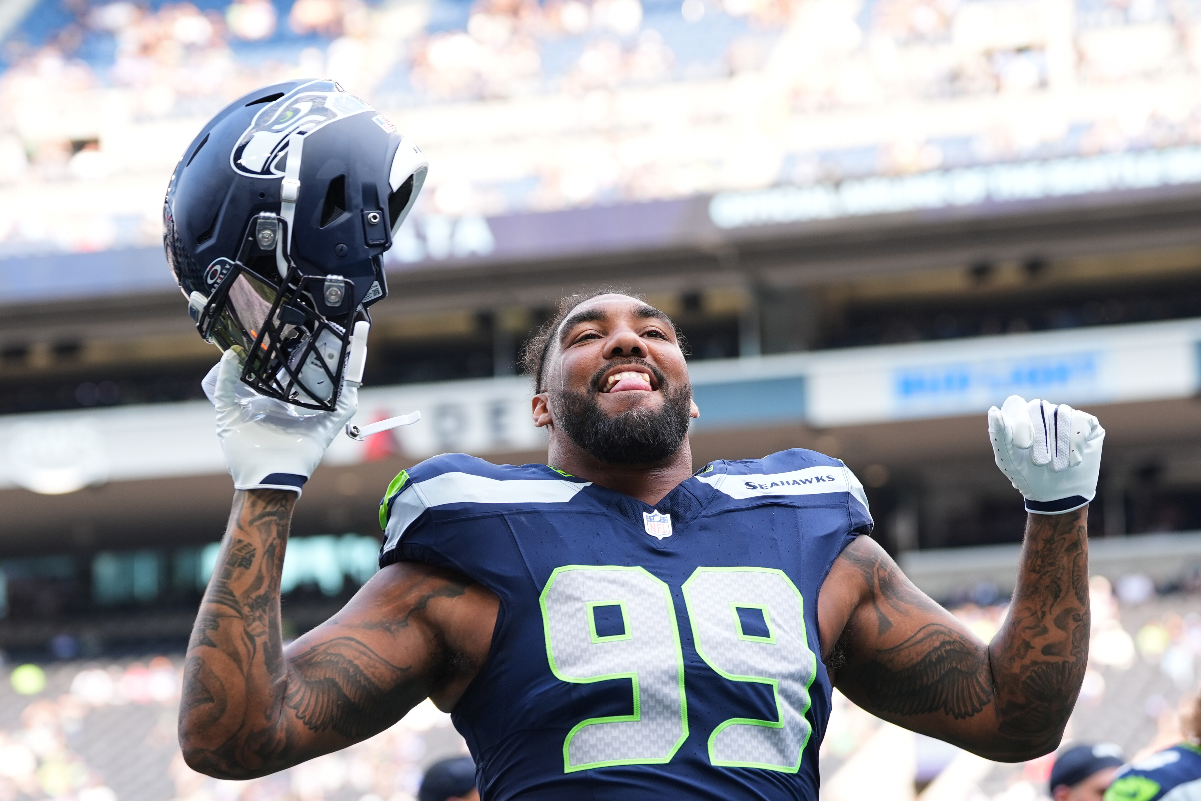 Seattle Seahawks' Leonard Williams responds to fans during warmups before an NFL preseason football game against the Dallas Cowboys, Saturday, Aug. 15, 2026, in Seattle. 