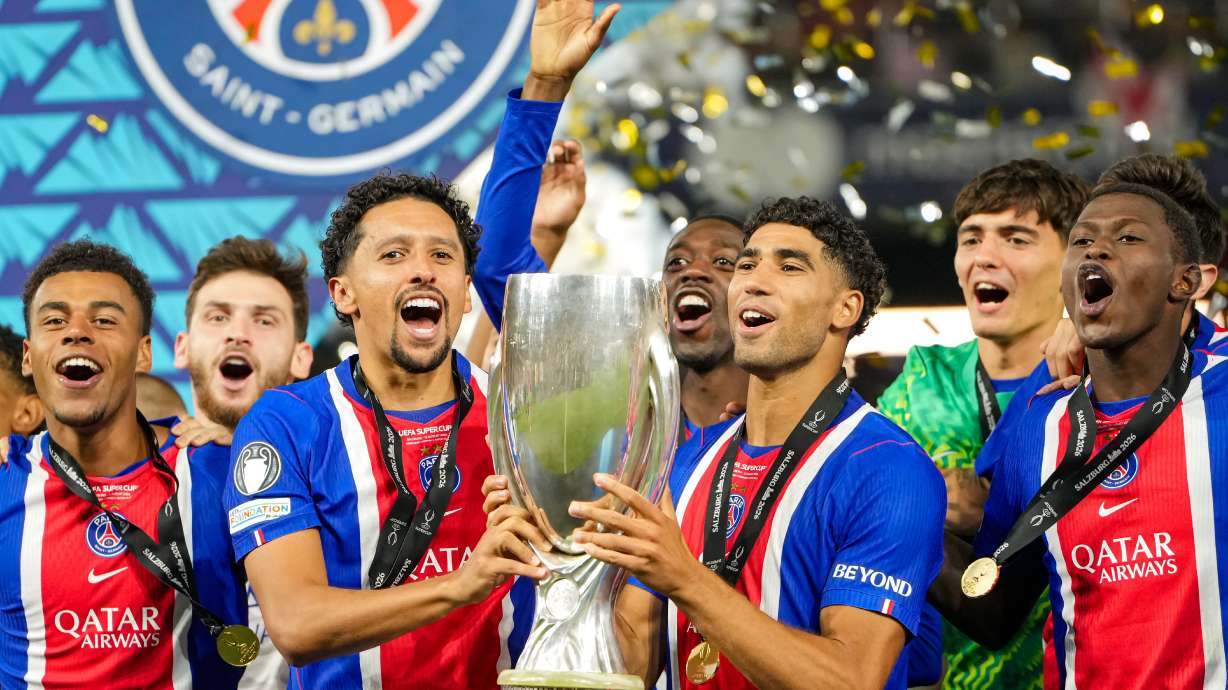 PSG's Marquinhos and PSG's Achraf Hakimi lift the trophy during celebrations at the end of the UEFA Super Cup soccer match between Paris Saint-Germain and Aston Villa in Salzburg, Austria, Wednesday, Aug.12, 2026.