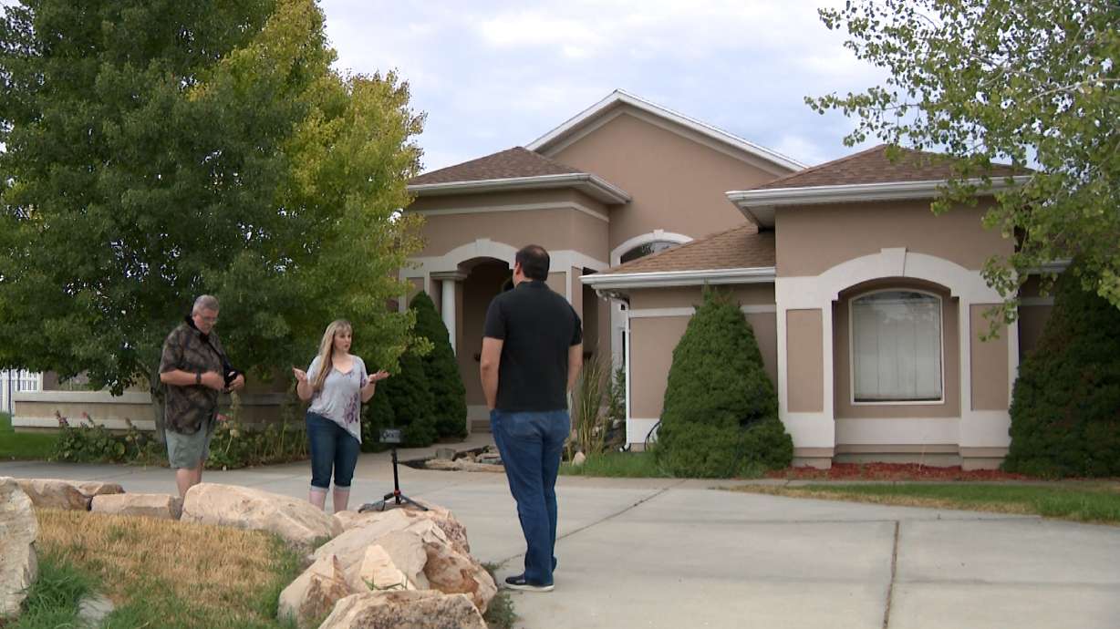 Kelly Stone talks with KSL Investigator Matt Gephardt outside her West Haven home about the repeated calls and texts from people interested in buying it.